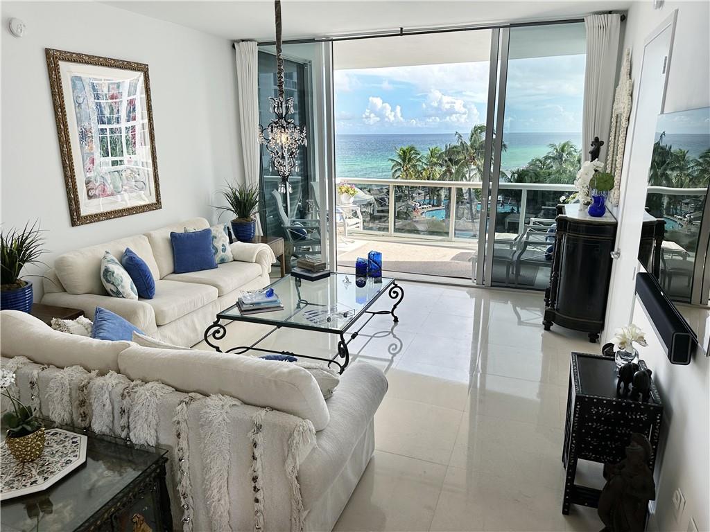 Wake up to a spectacular and happy tropical view on your terrace, and enjoy the luxurious beach lifestyle every day! This elegant and stylish 2 bed 2 1/2 bath condo in move in condition features 10 foot tall ceilings with floor to ceiling windows, Miele and SubZero appliances, and a spectacular treetop view of the aquamarine sea and lush paradise below.  Premiere level to enjoy the ocean view, while not being too high. Motorized Hunter Douglas Silhouette blinds, designer built-ins, limestone floor, mother of pearl wall, custom closets and media system included.  Beach club, tennis courts, three pools, spa, room service, valet. Kids playroom and great K-8 school across the street.  Easy walk to great restaurants, salons, banks and markets.    Live like you’re on vacation all year long!