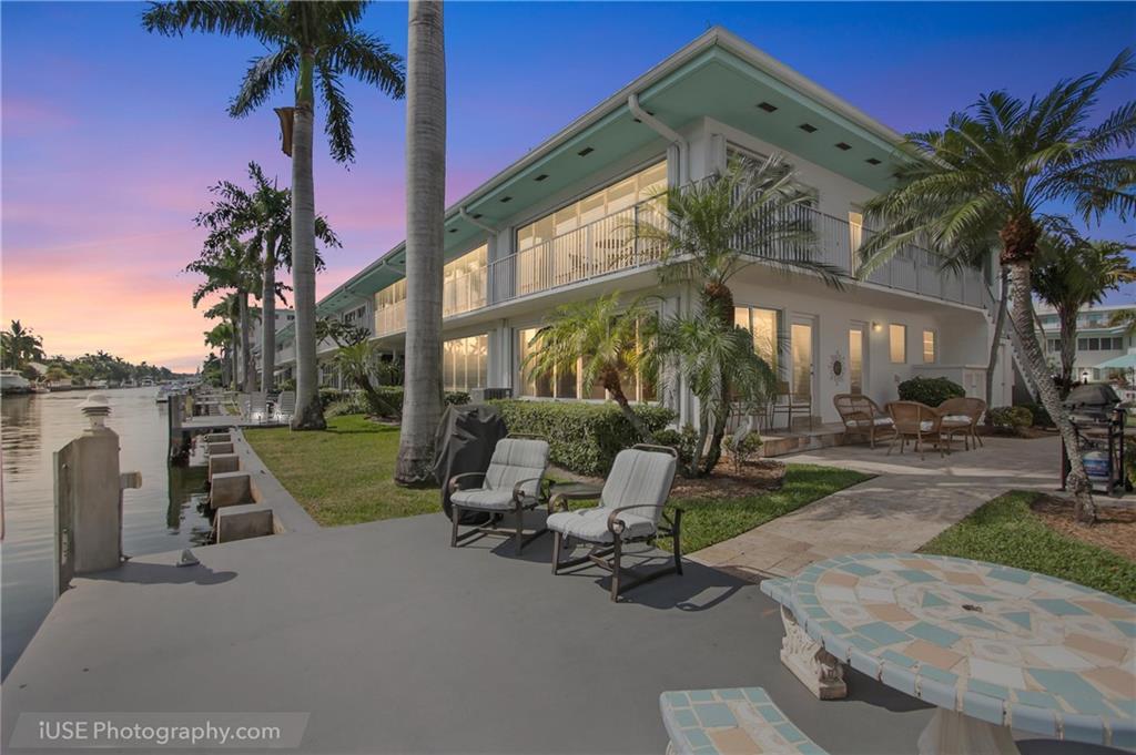 Finally! The Oasis package you've been waiting for!  WATERFRONT  resort living with amazing water views from almost every window (2) Prime quiet location walkable to Las Olas and the beach. (3) Hotly appreciating Isle of Venice Dr. with designated "land share" interest and covered parking INCLUDED in price (4) TWO updated master suites (5)  updated kitchen/ bath and porcelain tile, central A/c & heat; (6) BOAT DOCK with ocean access (7) In-unit laundry and shared patio with grill.   Owners can rent after one year.  On site management ideal for luxury living with spacious landscaped grounds and heated swimming pool on the tip of the Isle just off Las Olas Boulevard with all of its stores and restaurants.