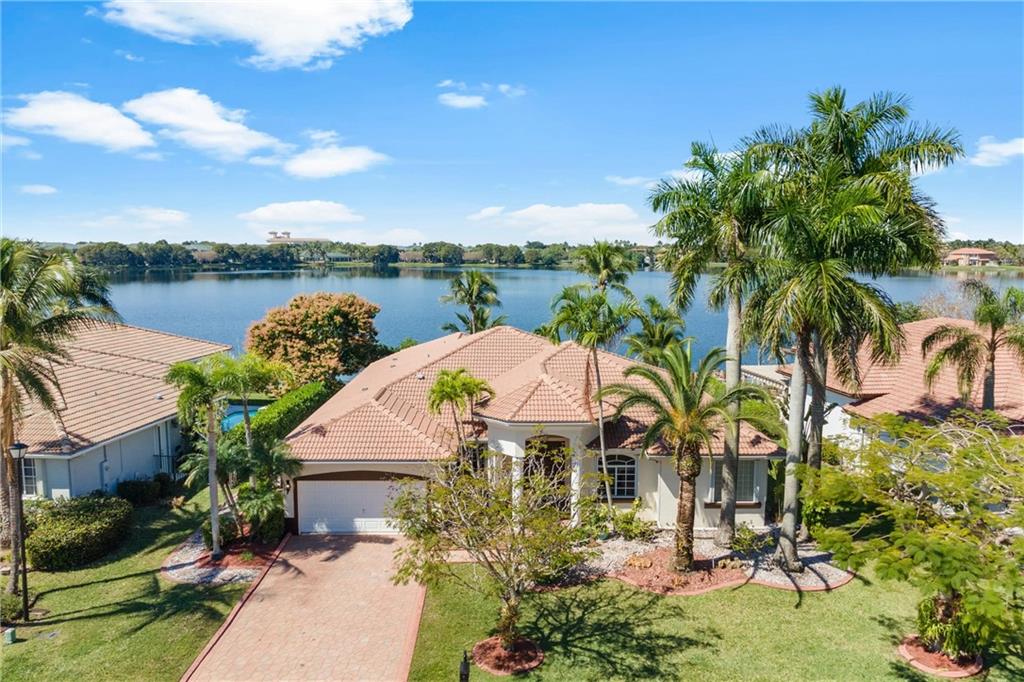 Stunning one of a kind water view you will not find anywhere else, all from the privacy of your own dock. Rarely available waterfront home with pool nestled in the guarded community of Mariners Cove. Backyard is Westward facing creating some of the most stunning sunset views on the water in Broward County. A freshwater angler's dream, keep your boat moored at your private dock just steps from your home. Fenced in pool terrace provides ample room for lounging and entertaining. Volume ceilings throughout. Split floor plan to include large main bedroom with water view. New roof installed in 2007.
