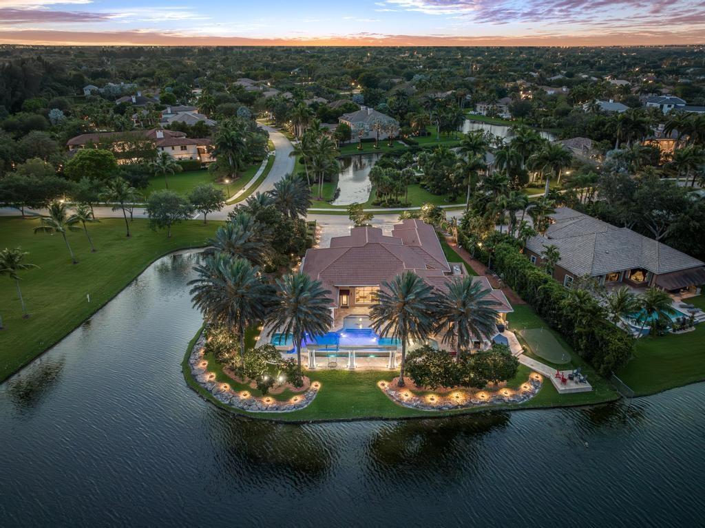 The Jewel of Stonebrook Estates! Spectacular waterfront point-lot with endless water view. This incomparable 6114 total sf, 1-story grand estate, features 6 generous bedrooms + office+ den, 5.5 bathrooms, 3-car garage, volume ceilings, 1room can be private guest suite, grand entry fountain, SS kitchen appliances & quartzite countertop. An entertainer’s outdoor lifestyle that leaves nothing left to be desired and is perfectly positioned for sun and shade! Custom infinity-edge pool, sun shelf, hot tub, in-pool dining tables, gazebo with summer kitchen, beer kegerator, Sonos speakers & a putting green overlooking the water views. 75KW full-house diesel generator, surveillance system & water softener/filtration system. Close to the renovated Clubhouse with playground, basketball, tennis & gym. Equestrian friendly community with trails and "Oakhill Equestrian Park" is located next to the Stonebrook Estates community.