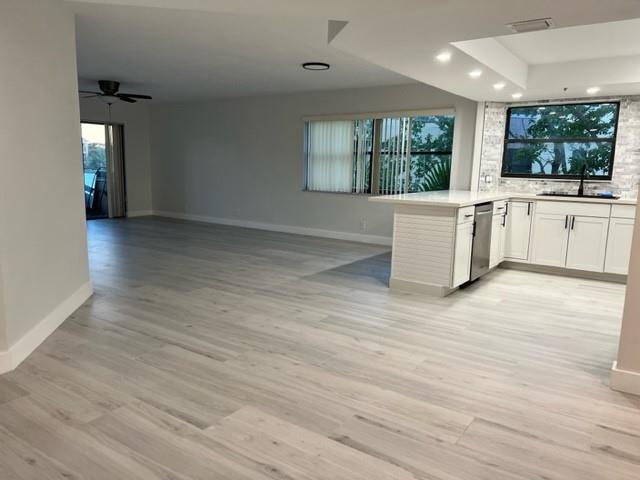 Gorgeous fully renovated 2/2 corner unit in Ocean Trace, a resort-like community with 2 pools, a lake, a clubhouse, and fitness center. 
This bright 3rd-floor condo has a spacious southwest-facing balcony that overlooks a pool and the lake and directly accesses the primary bedroom. The open-plan kitchen has new quartz counters, cabinets, and stainless appliances. New Tile floors throughout. New W/D. Large closets. NO Popcorn. Elevator building. Ample parking. HOA allows small pets and renting. Walk or bike to nearby parks and the Juno beaches! 
In a quiet area with low flood risk. Close to everything the Palm Beaches have to offer, including plenty of restaurants, golf courses, the Gardens Mall and only a 20-min drive to PBI airport.