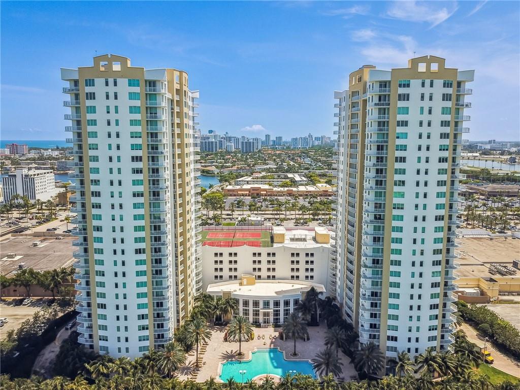 Stunning views in this large split floor plan 2 Bed 2 Bath in the Luxury Duo Condominium. Enjoy your mornings on your wraparound balcony, with views to the city, ocean, and golf course! The unit features a spacious kitchen with large island, granite countertops, and stainless steel appliances, with in-unit laundry, and impact windows throughout, and newly replaced balcony! The split floor plan allows for additional privacy between bedrooms for a more spacious feel. Convenient location provides walking access to Starbucks, many restaurants, and other shops! Sold furnished and has one assigned parking space! Less than a 10 min drive to the Beach, Aventura Mall, and Gulf Stream Park, amenities include 24/7 security, pool, free valet parking for a second car, gym, a sauna, and more!