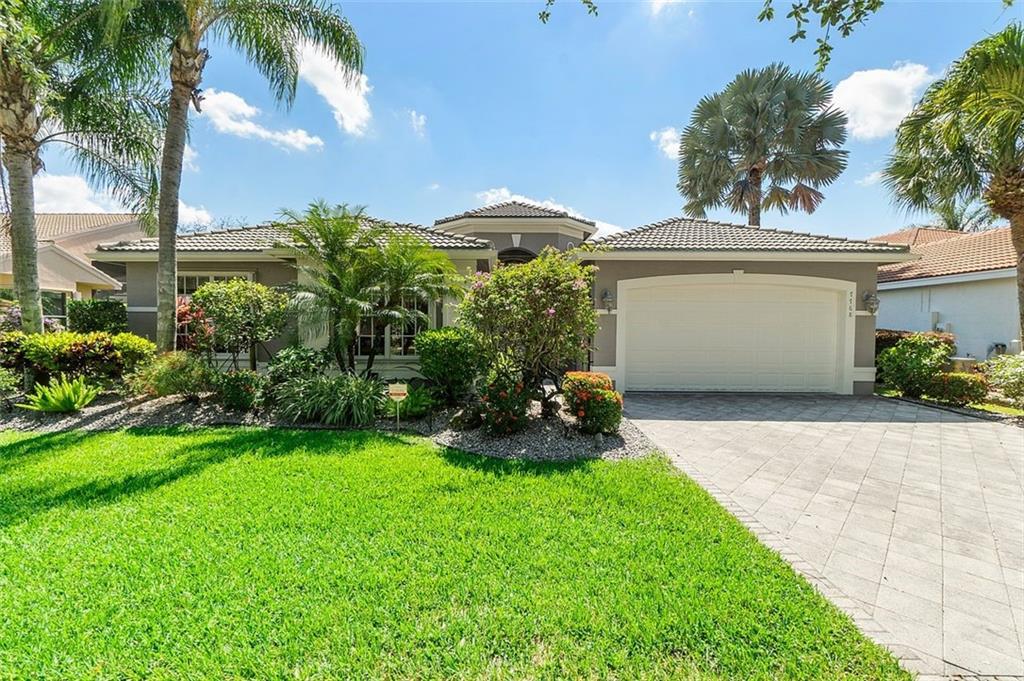 Welcome Home to this wonderful 4 bedroom, 2.5 bathroom, Madrid model home located in Valencia Shores. Spectacular water view can be seen as soon as you walk into this home, plus volume ceilings & open floor plan. This split floor plan, has the primary bedroom on one side and additional bedrooms on the other. The office has a large Murphy bed with storage - great for guests. The kitchen has updated wood cabinets, new flooring, backsplash & ample storage space. Walk outside onto the beautiful LARGE Lanai, with a lovely heated pool, lush landscaping, and a fenced backyard. It has full house generator & water purification system. A/C 2019, new washer/dryer, newer hot water heater, accordion hurricane shutters. Live the country club lifestyle (3 pools & athletic ctr) without the membership fee.