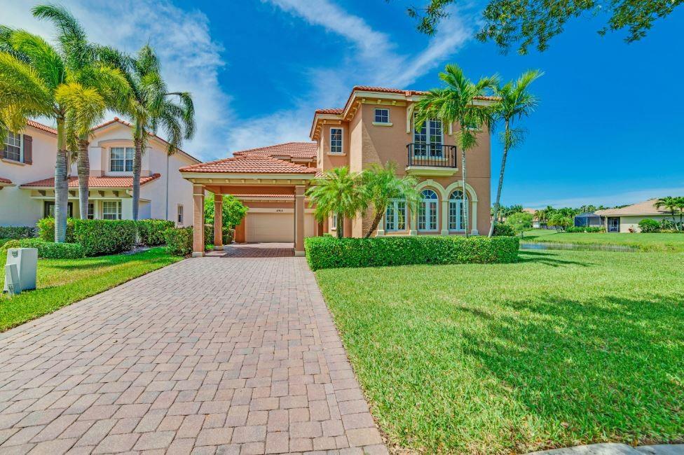 An exquisite property nestled in the prestigious Paloma gated community of Palm Beach Gardens! This stunning residence offers a perfect blend of luxury, comfort, and scenic beauty. As you step inside, you'll be captivated by the elegant design and modern features. The kitchen boasts a stylish island, complemented by sleek stainless steel appliances that make cooking a joy. Whether you're preparing a casual meal or hosting a dinner party, this kitchen is a culinary haven. Situated on a large corner lot, this home offers ample space for outdoor entertainment and relaxation. The 2-story barrel tile roof adds a touch of architectural charm. Imagine soaking up the sun by the shimmering pool and jacuzzi, while enjoying breathtaking views of the serene lake. The pool area is a private oasis where you can unwind and create lasting memories. When it comes to safety and security, this property leaves no stone unturned. The hurricane impact windows provide peace of mind during stormy weather, ensuring the protection of your loved ones and belongings. Inside, you'll find a spacious pantry, ideal for storing all your culinary essentials. The master suite boasts a generously sized walk-in closet, offering plenty of room for your wardrobe and accessories. With 4 bedrooms and 3.5 bathrooms, there's ample space for family and guests. Parking is a breeze with the 2-car garage and convenient carport, providing shelter for your vehicles and additional storage options. Residents of the Paloma community enjoy access to a range of amenities, including a refreshing pool and a clubhouse perfect for social gatherings and events. Take advantage of the vibrant Palm Beach Gardens lifestyle, which is also home to the prestigious Professional Golfers' Association of America (PGA). Don't miss this opportunity to own a slice of paradise in Palm Beach Gardens. This home offers luxury living, picturesque surroundings, and a prime location within a desirable community.