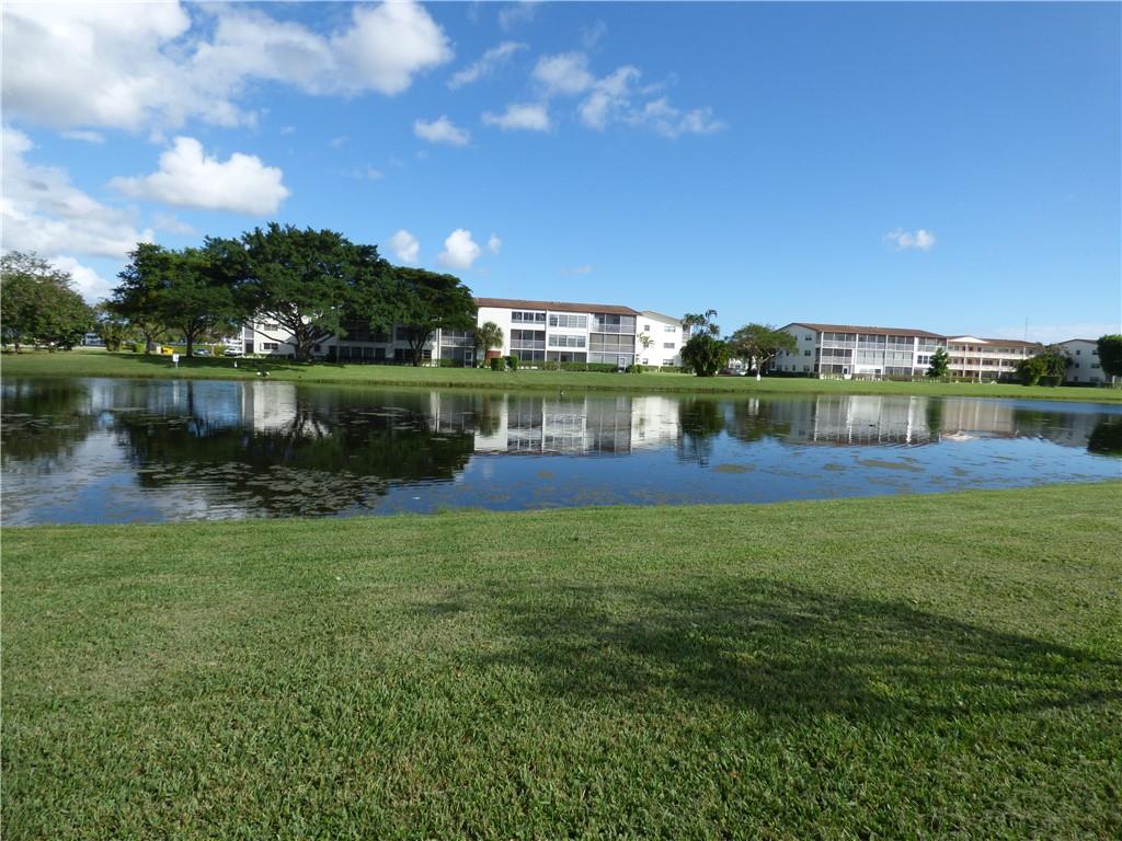 This first floor "walk out" unit is in need of your imagination & skills to make it wonderful. Conveniently located by the mail & laundry areas overlooking the little lake, this is a great opportunity to create your own slice of paradise. Guard Gated Century Village ~ One of the best "over 55 communities" in the area. This well appointed community offers just about every amenity that you can imagine including; an indoor swimming pool & outdoor pools too, a beautiful clubhouse hosting live shows, movies, theater, tennis, pickleball, beautifully landscaped jogging/walking paths, shuffleboard, bocce, bingo, canasta, card rooms, classes, bus rides to shopping, restaurants, events, day trips, clubs to join, BBQ areas, fitness centers, art studio, library & so very much more. Cash purchase. PLEASE INCLUDE ATTACHED (in "Supplements" on MLS) COMPLETED HOPA Addendum, Seller Disclosure & Condo Rider. Have Buyers initial Energy Efficiency Rating Brochure. Please include Proof of Funds and Credit Score.  Monthly Total for Maintenance fee is $483.27, comprised of an Association Fee of $214.32 to First Service Residential & Recreation Lease Fee of $268.95 to Cen-West Communities.  
Condo board requires minimum 30 days for approval. No Pets
Please do not send incomplete offers. Please use the Seller Completed Documents in MLS Supplements.