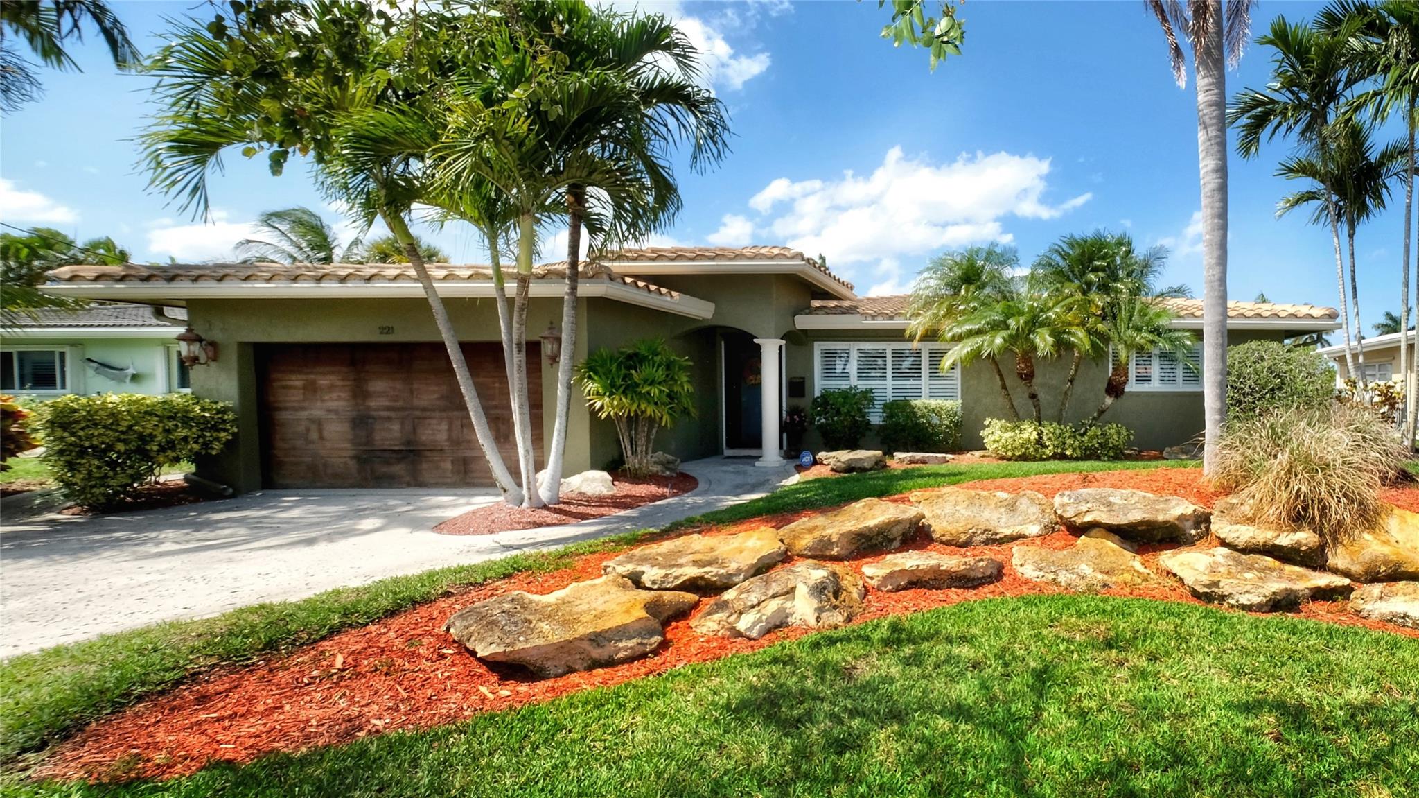 REDUCED!!!!   Feel the warmth and charm of this updated waterfront home located in East Pompano Beach!!! As you immediately enter the front door you are welcomed by a formal living room featuring a double sided wood burning fireplace. The 18" travertine floor will then guide you through the remodeled kitchen with granite counter tops into a HUGE second living room combined with a large dining area, fireplace, and spacious laundry room. The 2 sets of double doors open onto to a brick paver patio leading to a commercial grade CONCRETE seawall built to todays current building code along with a 10,000 boat lift. The spacious master suite offers a remodeled bathroom tastefully finished with an oversized shower, large walk in closet, and double doors opening to a small deck. NO HOA!!!