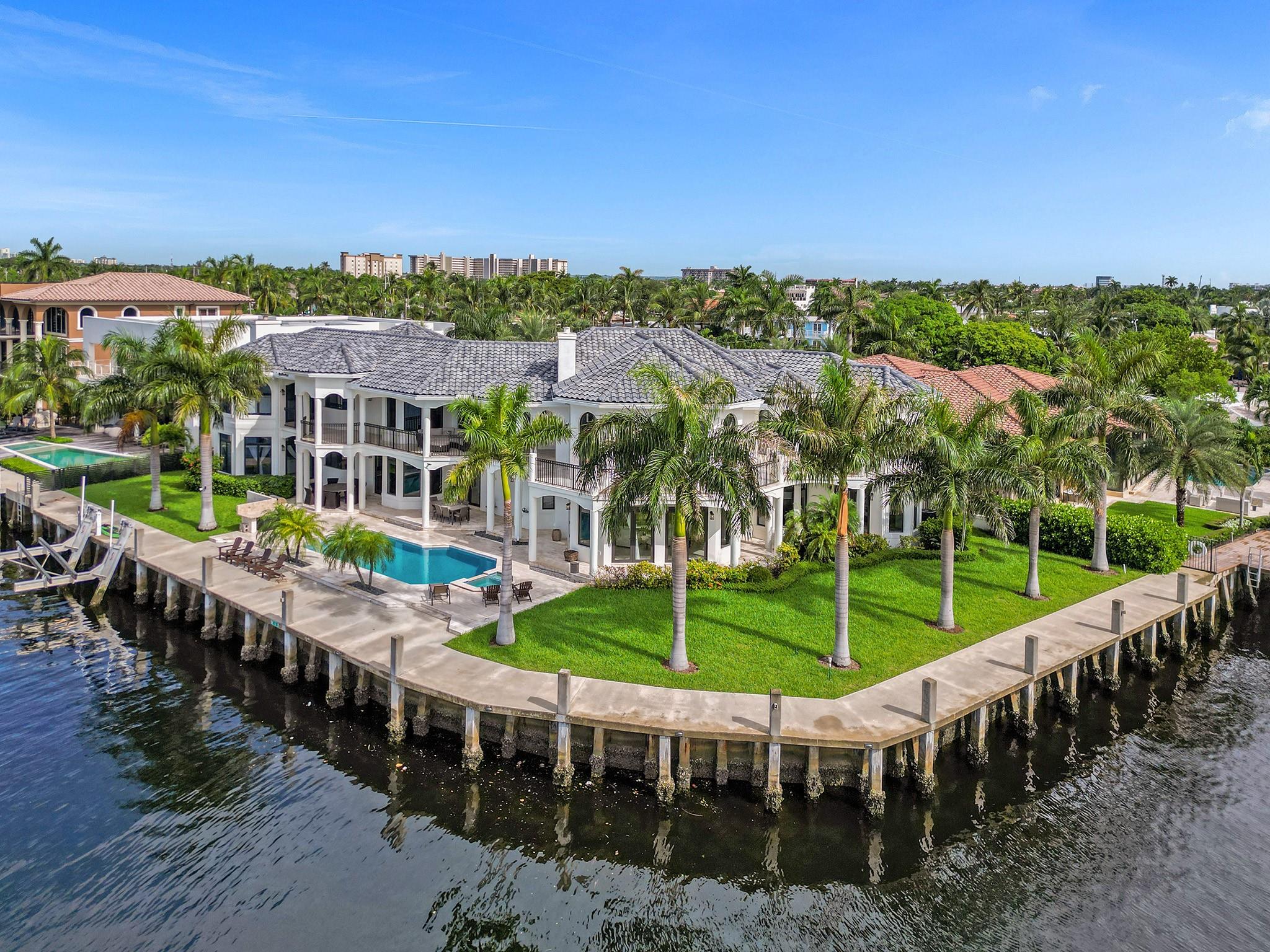 We Are Proud To Offer & Represent This Elegantly Remastered Luxury Direct Intracoastal Home! From the time one approaches the grand entrance, gorgeous dramatic dueling staircases & a catwalk greet, soaring ceilings, incredible natural light, a perfect blend of beauty, vast space to relax or entertain with & sophistication await! The open & airy catwalk allows for continued lighting & as one walks farther in, this home offers a sweeping south by southeast views, across the generous pool/spa/summer kitchen deck, 220' of deepwater frontage appointed w/a newer concrete dock & seawall & a boat parade every day. The generous 6 bed, 5 full baths & 1 half bath floorplan can accommodate your family & guests with great views from almost every room. Close to the beach/inlet, entertainment & more!