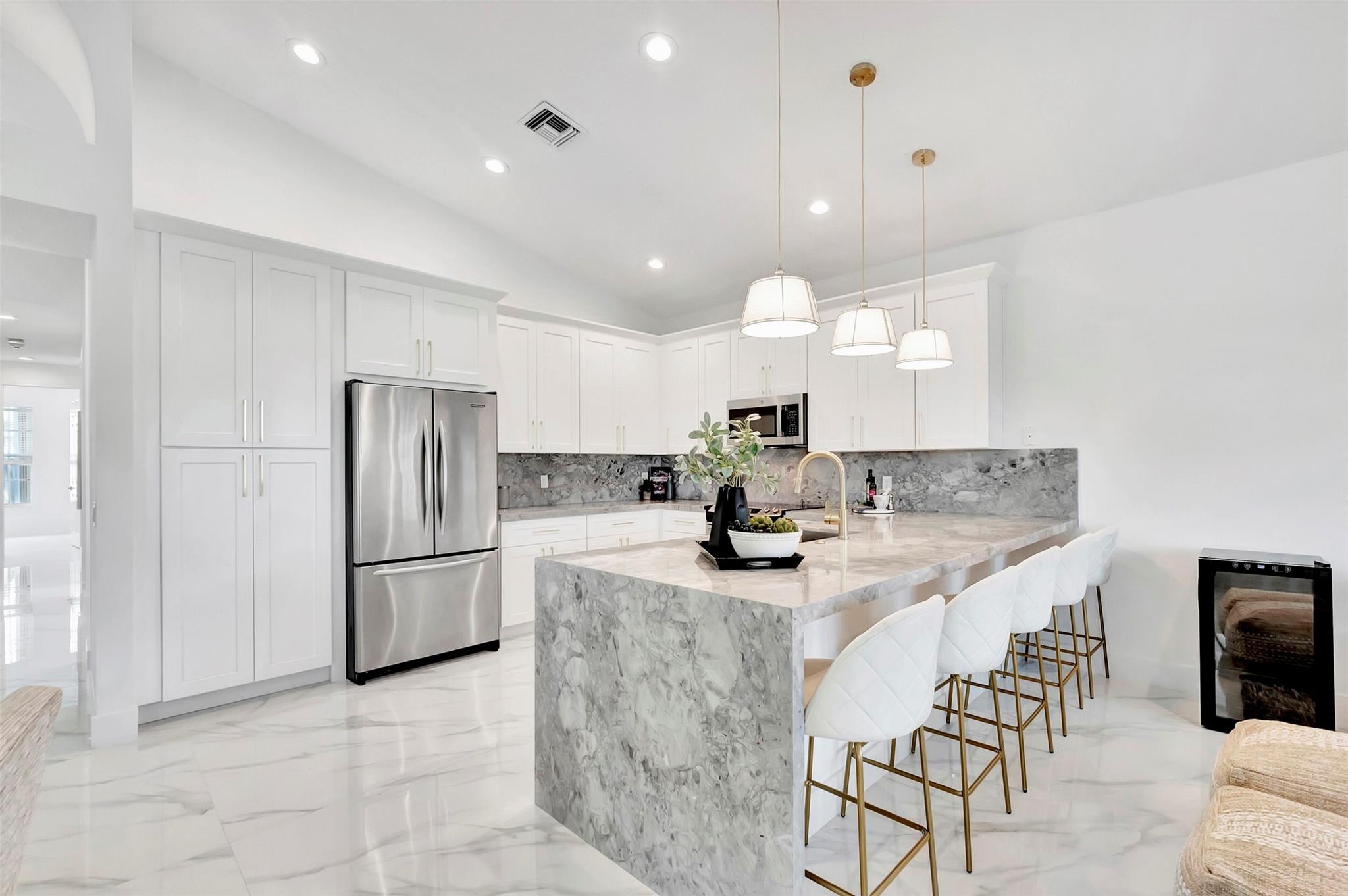 Move right into the only brand new MZB designs custom designed home in all of Valencia on the water! COMPLETELY RENOVATED lake front, 4 bedroom 3 bath home. Top of the line finishes include: a NEW ROOF, accordion hurricane shutters, and 48 "porcelain tile floors. Your primary bedroom over looks the lake, and has his and hers walk in closets.  Oversized shower with soaking tub, fully enclosed outdoor sun room overlooking the lake, brand new custom kitchen all ready for you to entertain at!
*Pick your exterior paint colors to be done by HOA.  

Come enjoy open concept living in Valencia Lakes, a gated 55+ community that offers a resort style pool, cafe, gym, card rooms, pickle ball, tennis courts and more. $6m Clubhouse renovation assessment paid by seller. Valencia special assessment paid by seller