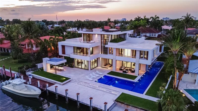First time offered on the market since the fruition of its construction in 2015. This 3-story carefully customized contemporary residence is truly one of a kind masterpiece. 110ft on the water, 130ft deep lot. A gracious courtyard of orchids and water features greet you at the entryway. Step from the outside and into it’s matching-interior features of polished limestone, Brazilian IPE wood floors and stone walls engulfed with natural light. Solid mahogany floor-to-ceiling impact windows and doors with an 80ft lap pool and spa just beyond the glass in the great room creating an open concept and perfect energy. Gourmet kitchen, summer kitchen, full house generator and elevator. third floor designed for complete entertainment with a slice of main intracoastal E views.