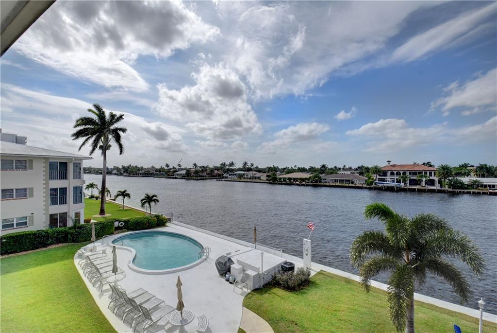 A PIECE OF HEAVEN YOURS TO ENJOY! A BOAT PARADE EVERY DAY! THIS 2B/2B DIRECT INTRACOASTAL FRONT CONDO IS MOVE-IN READY. REMODELED KITCHEN, TILED THROUGHOUT (SANDY FEET NO PROBLEM), L-SHAPE LIVING/DINING AREA, REMODELED MASTER & GUEST BATHS, CROWN MOLDING, 8 YEAR SAFETY GLASS PLUS ELECTRIC SHUTTERS AT SCREENED WINDOWS/DOORS, HARD-WIRED FIRE ALARM, NEW A/C, FIRE PIT SEATING WHERE YOU CAN ENJOY OCCASIONAL COOL EVENINGS ...NOTHING IS LEFT TO CHANCE. SO CLOSE TO THE BEACH, YOU CAN ALMOST HEAR THE OCEAN. WITH THE NEW POMPANO PIER, UP-SCALE RESTAURANTS, HOTELS, SHOPPING, & THE MULTI-MILLION DOLLAR, WORLD CLASS LUXURY MARKET EXPANSION IN PLACE, POMPANO BEACH IS THE HAPPENING PLACE. THE TIME IS NOW TO BUY AND ENJOY FLORIDA AT ITS BEST AT A PRICE YOU CAN'T BEAT. PLUS LOW MAINTENANCE!