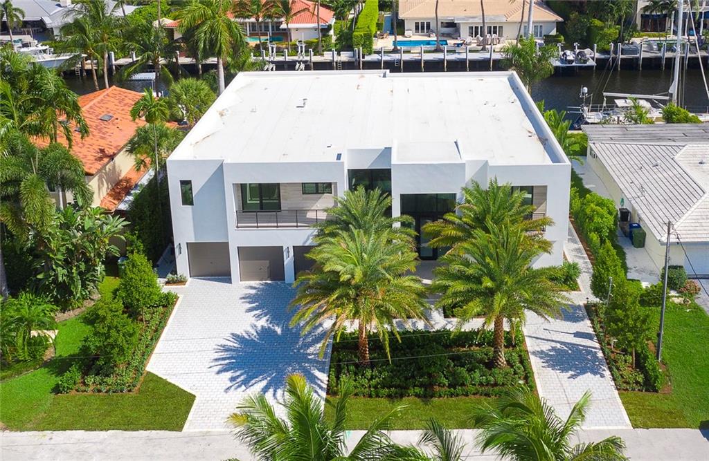 Newly completed, this stunning Coastal Modern deep-water residence will comfortably accommodate a yacht up to 75ft on a deep & wide waterway. Located just 4 residences from the point this may be the perfect boater or entertainer's choice. Floor to ceiling windows offer a dramatic entry foyer to the great room with fireplace, expansive Chef's kitchen, adjoining family room & 1st level secondary Master/VIP Suite. Elevator access to a loft office/guest lounge, ultra-luxurious Master Suite & 3 additional en-suite bedrooms. Enjoy the expansive covered area, Summer kitchen & concrete dock. Intracoastal views from the dock/pool area. Private Marina & Surf Club also offered to residents.