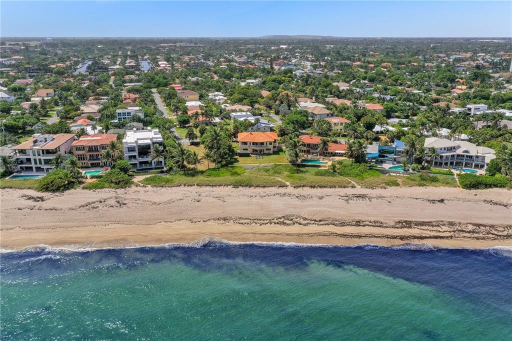 Walled and gated for privacy and security, this direct Oceanfront Estate is perfectly positioned an an over-sized 16,525 +/- Square Foot lot with 96' direct Oceanfront in the quiet seaside community of Hillsboro Shores. This Mid-Century Estate enjoys spectacular views of the Hillsboro Lighthouse and tranquil Ocean breezes.