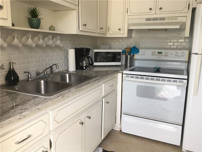 Large 1/1 in a desirable location, next to shopping, banks, restaurants and beaches. No Carpet, large walking closet, new bath, granite in the Kitchen. If you are an investors is a dream come true. You can rent! Unit is rented to a great couple paying $1250 per month, lease expires 07/05/22. Only showing with a sign contract. You can also rent for just a few months and live here for few months. Bayview school district. Has a land lease of $256 per month for another 40 years. IT IS a CO OP. Unit has a little storage and has shutters protection for hurricane.