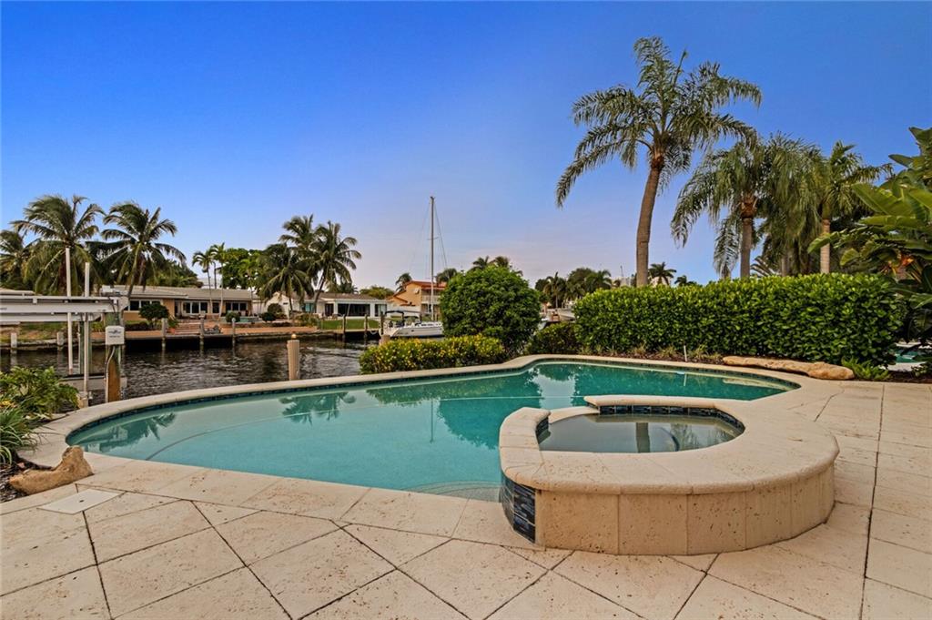 Accepting Backup Offers!! Enjoy South Florida living in this beautifully renovated 3 Bedroom Waterfront Home in Pompano Shores! Truly a Boater's Dream Home only a few homes from Intracoastal, Wide Canal for large boats, 16000lb Boat Lift, 70 ft of Deepwater Dockage, Direct Ocean Access! Spectacular Water Views greet you from the huge family room (38x20) with built in Quartz bar top, perfect for entertaining! Gourmet Eat-In Kitchen with Dining Room features: Granite Countertops, High-End Stainless Steel Appliances, Samsung slide-in Gas Range, Wine Cooler. Marble Flooring throughout. Three Spacious Bedrooms & Updated Guest Bathrooms. Large Master Bedroom has sliding doors overlooking patio, Walk-In Closet! Impact Windows! Tropical Outdoor Paradise has Covered Patio, Heated Pool with Spa. Master and Bath 3 have barrier-free showers. Enjoy the year-round security of impact windows and doors, 24-hour color cameras and alarm accessible via apps, and standby generator on natural gas, while your boat is kept high and dry. Wired for security, work-at-home, and entertainment. Every room is light and bright with large windows and 71 recessed LED lights.