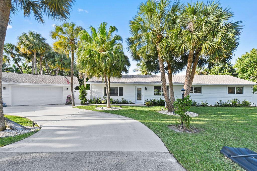 Location, Location, Location! Great opportunity to live on the 'Holiday Tree' Street! The beautiful tree-lined neighborhood of Snug Harbor Estates is one of Palm Beach Gardens most desired neighborhoods. Come see where modern luxury meets tropical charm in this coastal, 3 bedroom + 2 bathroom, CBS residence that is just steps from the intracoastal. This ranch style home has two living areas, sits on 1/3 acre, has an oversized attached garage & more!  Plenty of space to bring your boat and your RV! A wonderful large homesite adorned by a beautiful tropical pool and patio. The oversized backyard oasis gives you options for a covered sitting area or a campfire setting to enjoy your Florida paradise! There are multiple open space areas of lush green grass perfect to roam for children, animals or the gardener. The interior floor plan has been opened up, so every living area meets the massive kitchen and substantially large island. The kitchen finishings include luxury quartz countertops, designer light fixtures, blue mosaic backsplash, stainless steel appliances and hood, soft close cabinetry, large farm sink, spacious built-in storage cabinetry. The new renovations reflect a beautiful light sandy colored laminate flooring, freshly painted bright walls and recessed lighting. The ultra-elegant and matching bathrooms give the ultimate feel of modern luxury. The stunning oak tree lined street has no HOA. Close to shopping, restaurants, entertainment, I-95, Turnpike, Palm Beach State College, pristine beaches and so much more.