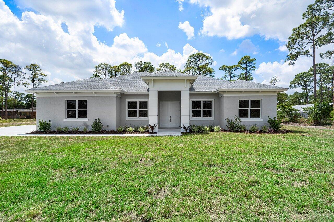 Are you looking for a NEW CONSTRUCTION home located in a prime location? Come see this beauty set on over 1 acre with no HOA that is ready for you to move right in.  The attention to detail is evident in this 4 bedroom, 2 bathroom home that offers 10 foot ceilings, large format porcelain wood tile flooring, a full concrete driveway, IMPACT WINDOWS, upgraded bathrooms with a free standing tub in the primary suite and more! Perfect for entertaining with a bright, open living area and covered patio! The kitchen features quartz countertops and large island, soft close 42 in cabinets and stainless steel appliances. Just minutes from shopping, top rated schools, restaurants and main roads. Scheudle an appointment today.