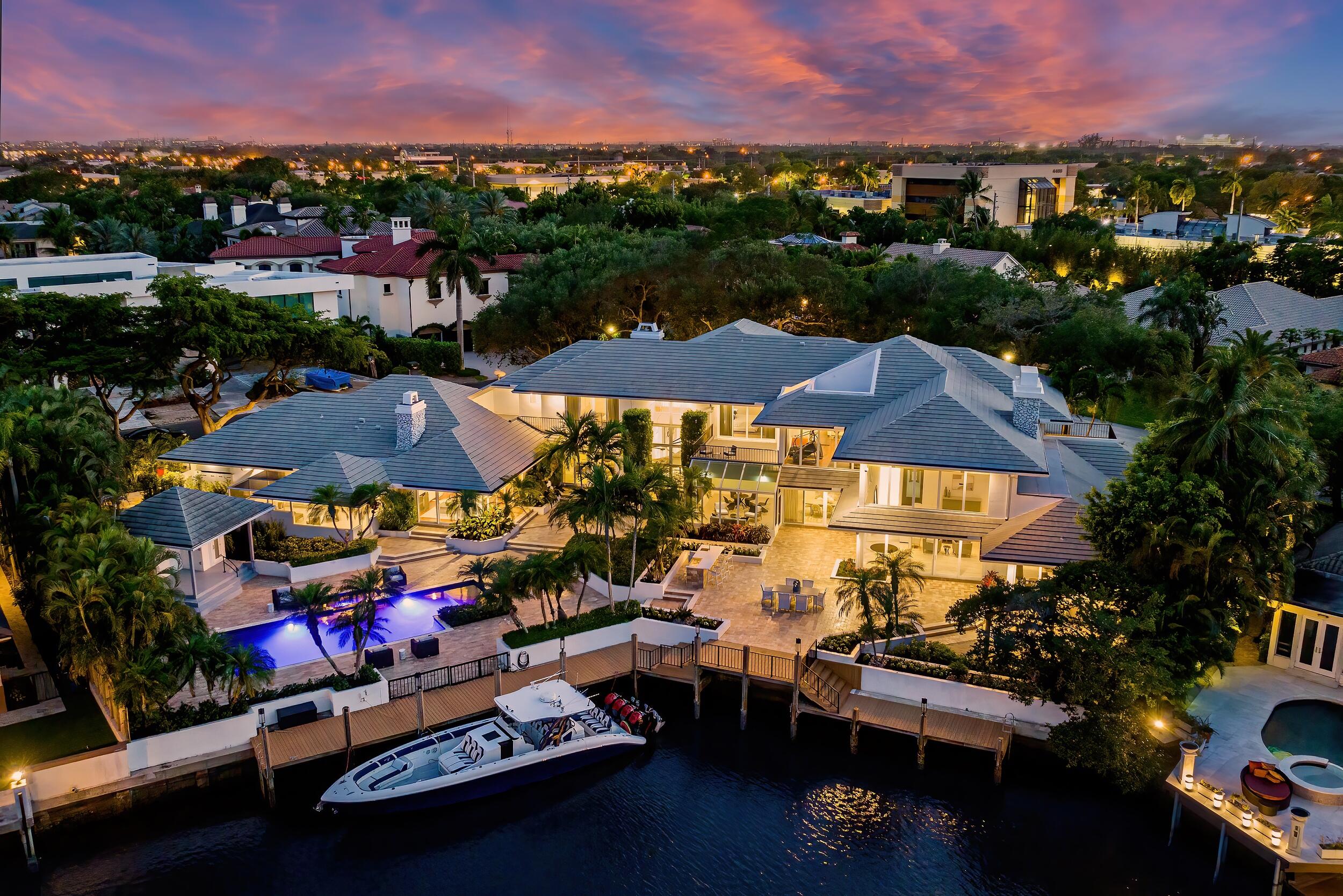 Extraordinary value in the most highly sought after gated waterfront community in East Boca Raton. The price has been adjusted for immediate sale. The Sanctuary, a private enclave in Boca Raton listed by Forbes as one of the most exclusive gated communities in the United States, provides an appropriate setting for this contemporary masterpiece sited on two prized waterfront lots. This 12,000-square-foot estate is cast in elegance, artful accents, and resort-style sophistication. A broad canopy of arching tree branches provides cover leading to a gated courtyard entrance. It's a thread of chic comfort and mesmerizing awe that extends throughout the five-bedroom layout (with 7 1/2 baths). with bright white stone countertops and cabinetry, Wolf and Sub-Zero appliances, a private butler's pantry, a separate storage room, and an oversized island with 360-degree storage, and a temperature-controlled Vindegarde designer wine vault. 

The kitchen and adjoining breakfast area open to an outdoor covered dining and entertaining space, perfect for enjoying a morning cup of coffee while reveling in the splendor of the estate's beautifully appointed outdoor spaces. The expansive primary quarters, spread across the entire south wing of the property, boasts a full menu of luxury features. Highlights include a sitting room/living space with a gas fireplace, an adjoining home office, oversized boutique-style closets with custom shelving (including a bonus cedar closet), and a mammoth spa-like bathroom with steam shower and soaking tub. Sliding doors off the primary bath open to a screened outdoor relaxation and massage area, complete with a soothing Bali-inspired water feature. The indoor-outdoor flow of the home seamlessly integrates entertaining spaces along the north wing of the main floor, including a theater room (with a 120-inch screen and comfortable seating for 14), and a wellness area just off the lounge with a state-of-the-art gym, full bath and commercial-sized dry sauna by Helo Finland. 

The sense of serenity and style extends to an exquisite exterior, highlighted by a saltwater pool with sun shelf and spa that overlooks the property's 140 feet of water frontage (with direct ocean access). The richly landscaped outdoor area&#x14;enhanced by dramatic nighttime lighting&#x14;also includes a summer kitchen, and a standalone cabana pavilion with a full bath and ample storage. Meanwhile, the 120-foot angled dock, with room to host two yachts, is equipped with 30 amp shore power connection. Additional living amenities include an upstairs gym, maid/au-pair quarters with separate entrance, a glass elevator, a four-bay garage with an adjoining workshop, and private balconies off each upstairs guest bedroom. As for the prehistoric element, a striking artifact in the great room dating back some 70 million years offers a rare glimpse into our past. For a full-ask offer, the seller will include a display piece like no other as part of the purchase&#x14;the skull of a Mosasaur dinosaur. These large marine creatures dominated the ocean as apex predators during the late Cretaceous period; most were 30 feet to 50 feet in length.

Sophisticated resort-style living awaits.