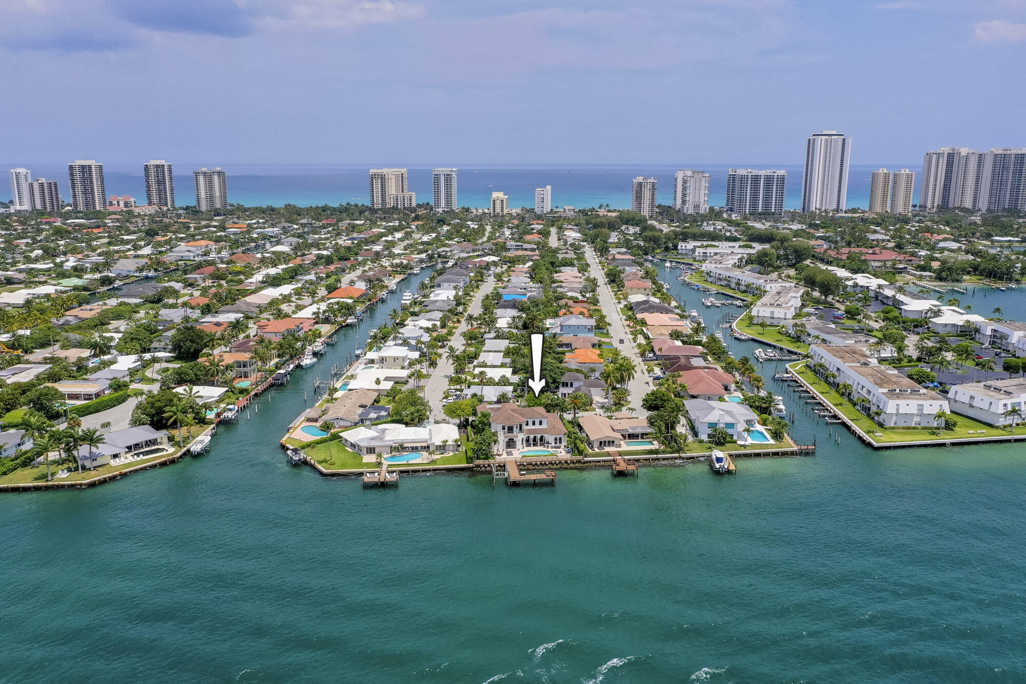 A truly stunning waterfront property with the best views on all of Singer Island. This 4BR 4/2BA + loft home is the ultimate boater's paradise, complete with a private dock and 12,000 lb boat lift. The level of detail and sophistication can be seen throughout, from the grand entrance with coffered volume ceilings, crown moldings, and built-in surround sound to the custom kitchen with seamless gas appliances and beautiful wood cabinetry. Enjoy breathtaking sunsets and skyline views from the back patio featuring a full summer kitchen, heated pool and spillover spa, all surrounded by the crystal blue waters of the intracoastal. From the elegant finishes to the unparalleled water views, this spectacular home is the perfect South Florida retreat.