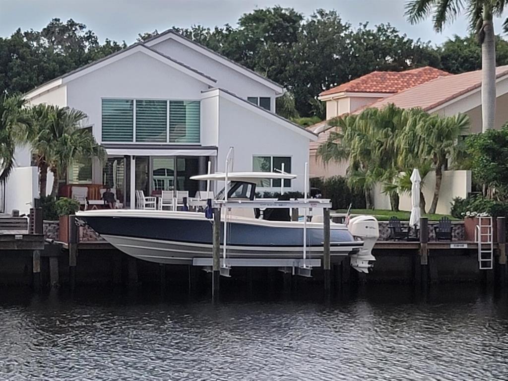 A Dream Come True!  Move in to a waterfront/intracoastal dream home recently renovated. Elegance awaits you4bedroom/5.1bath plus den, elevator. Direct waterfront in the exclusive community of Frenchman's Creek Beach and Country Club. Built in outdoor kitchen and bar with pizza oven.  New twin engine 2021 Chris Craft 30 foot boat with head 28 hours on boat. Brand new lift. New golf cart. New roof, complete hurricane impact glass, porcelain tile throughout main floor, updated kitchen and baths, renovated pool and spa with travertine deck.