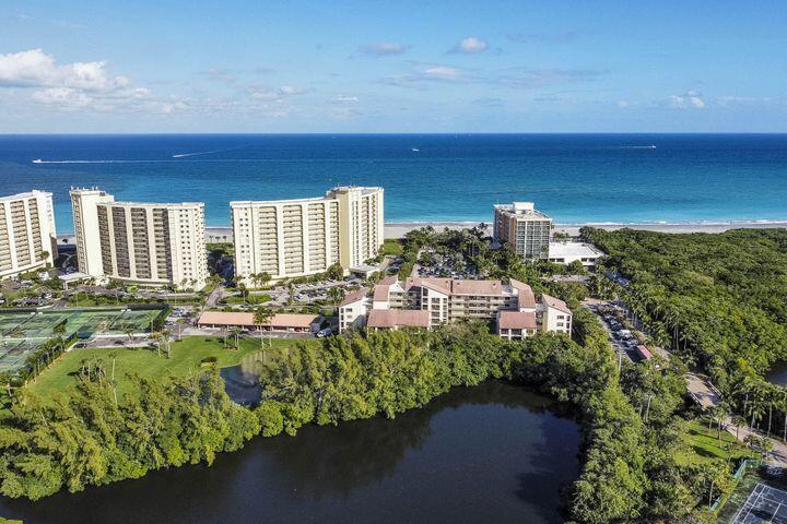 This is the ''Hidden Gem'' of Ocean Trail surrounded by the Ocean, the Jupiter Estuary and Carlin Park. Beach access is a 2 minute walk, as well as the Jupiter Resort Hotel where Ocean Trail residents have special gated access. Ocean Trail is central to the best restaurants and retail Jupiter has to offer as well as the one of the biggest beaches in Palm Beach County. The huge balcony overlooks the Jupiter Estuary and is a ''nature lovers paradise.'' The heart of this condo is a fully renovated and reimagined chef's kitchen with 6-person granite dining-bar and Sub-Zero and Miele appliances. The primary bedroom suite and bathroom are resort-like with an open bath and huge walk-in shower and has second bedroom positioned on other side of condo for privacy.