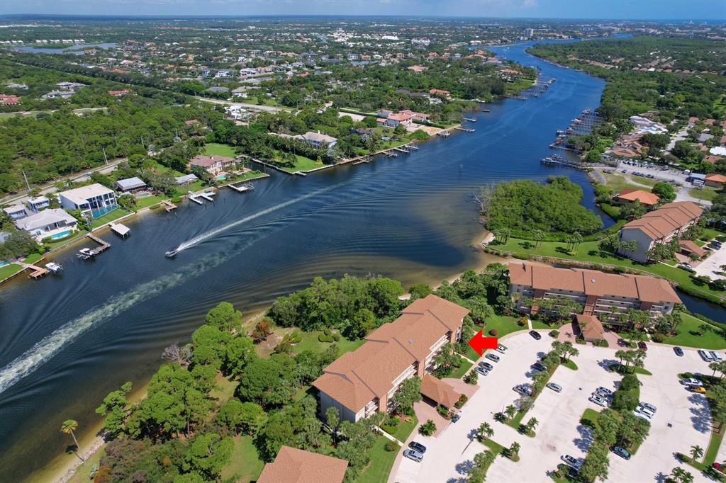 Bring your golf clubs, bikes, beach chairs and paddleboards! Enjoy all the outdoor activities the area has to offer! This stunning 1st flr end unit on the intracoastal lives like a house with lush tropical gardens & private intracoastal beach just steps from your secluded patio spaces. Renovated bright kitchen w/ white shaker cabinets, newer SS appliances, glass subway backsplash, Quartz-like countertops & pendant lighting. Up-graded bthrms & custom-built mstr closet. A split floor plan offers privacy for you & your guests, w/ a large storage rm for all your recreational toys! The community features 4 heated pools, tennis courts, bocce ball, and ICW picnic area. Professionally maintained tropical landscaping w/ walkways throughout the complex. Minutes to beach, Publix shopping plaza & rest