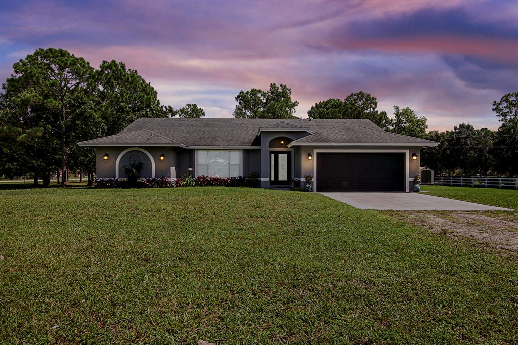 This pristine equestrian dream home is one of the most rare properties in all of Loxahatchee. One of the features making this property so desirable is its LOCATION. Beyond being in close proximity to shopping dining and highways, this home neighbors the public Hamlin Equestrian Park which features four Equestrian arenas. Light dances into this renovated and immaculate 4 bed, 3 bath concrete block home situated on 2.54 acres of land featuring two on-suits with exterior access to the tranquil backyard where endless possibility awaits. The community of Loxahatchee is highly regarded as a haven for people and their pets, so please know your fur babies, feathered flock or hooved companions are welcomed here. This property embodies convenient country living and timeless beauty.
