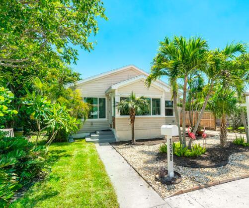Just say NO to generic houses - this move-in ready Lake Worth Beach 2 BR (w/ den) home has historic charm while being nearly brand new inside. NO HOA so you can move right in or rent. Kitchen was completely renovated w/ white cabinets appliances w/ natural gas stove. The interior was opened up to create an open concept. Original hardwood floors were refinished + sparkle. A long driveway goes the length of the property to accommodate private off-street parking plus additional storage for a small boat, jetskis, paddle boards or other toys. Did we mention the 2 car garage? (You can also convert it into a workshop or additional living space) Property is private w/ 6 foot privacy fencing + lush foliage. The authentic thatched tiki hut provides additional shaded entertaining spaces.