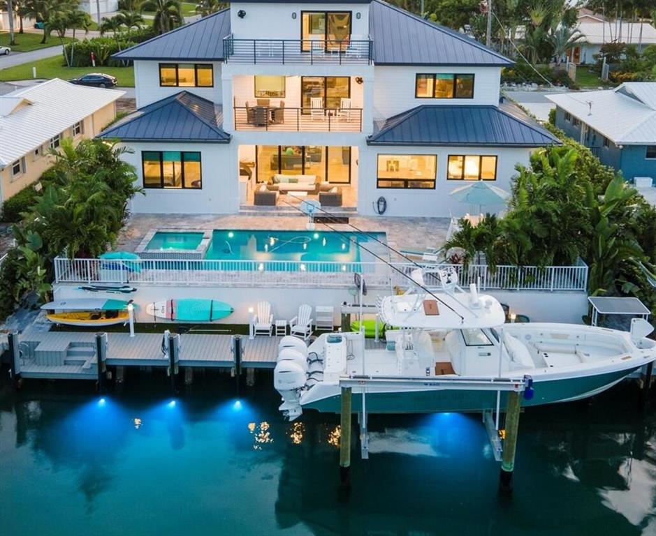 Maticulous TRANSITIONAL-STYLE NEW CONSTRUCTION home on the TURQUOISE DEEP-WATER CANAL just off the Intracoastal within Waterway Village! This is an incredible BOATER'S DREAM LOCATION with BAHAMA BLUE WATER, no bridges and MINUTES AWAY FROM INLET is a must see before it is gone!  With desired Eastern exposure, this 5,143 AC sf residence was constructed with the finest workmanship, great design and functionality, high quality, and superb finishes, some of the features an open-floor plan concept, volume ceilings with shiplap, tile/wood flooring throughout, solid core doors, centralized vacuum system, an oversized A/C meticulaous mancave  garage, all impact glass windows & doors, including the stunning custom double front door.  See additional Supplement.