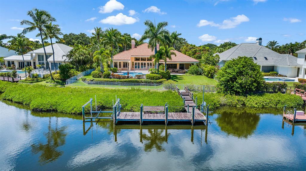 Custom Waterfront Estate Home with convenient location close to the main gate and clubhouse. If you like large, bright and sunny rooms then this property is the one for you. Lavish Owner's Retreat overlooking the waterway, with sitting room, 2 walk in closets, 2 baths, granite countertop, large tub and tons of storage.  2 oversized guest suites with private baths, large closets and are located off their own wing.  Lush tropical landscaping surrounds the expansive backyard that provides beauty and privacy.