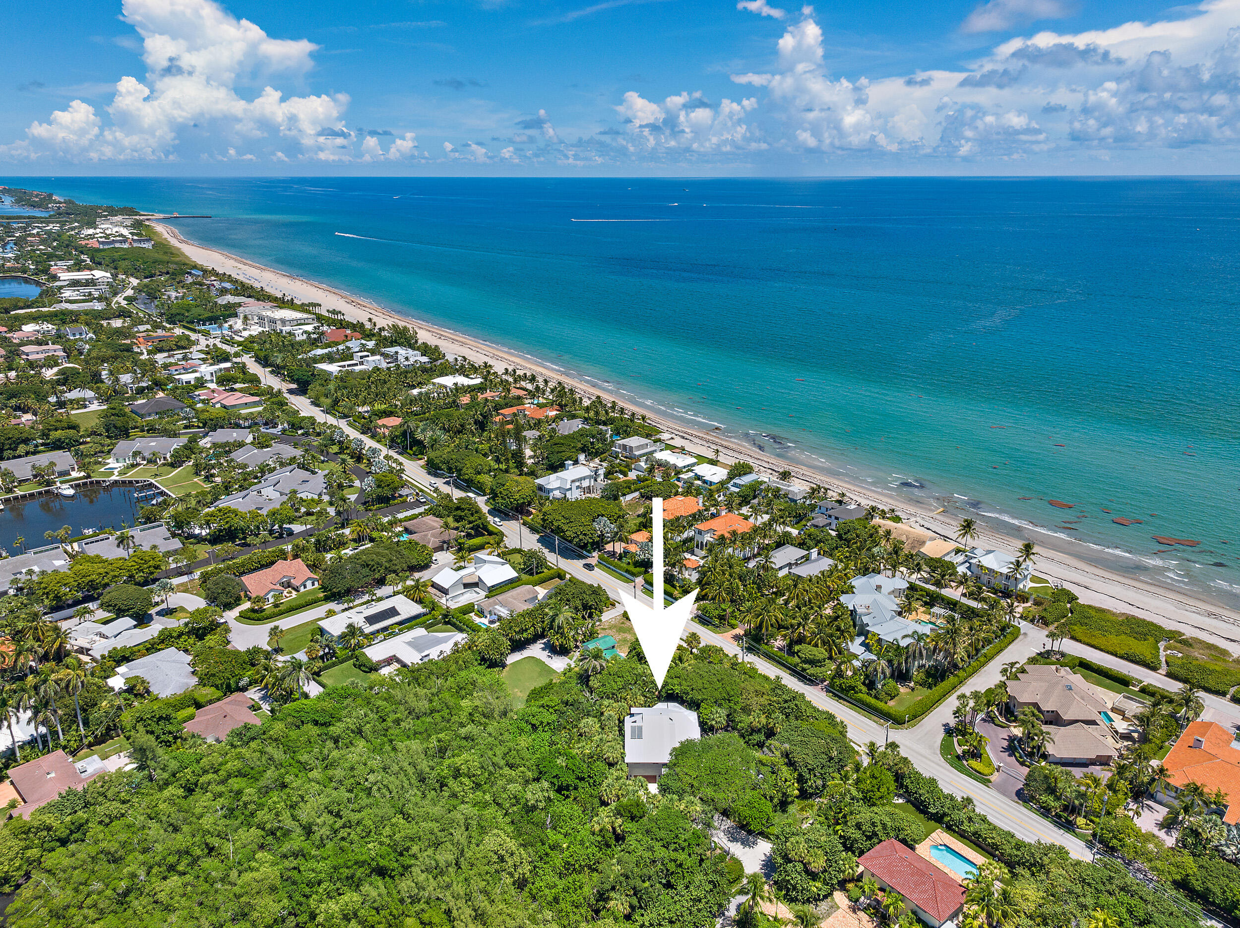 Location Location. Rare opportunity to live in a tropical oasis on just over 1/2 acre of land one block from the blue water beaches of the Atlantic Ocean. Stroll down your private lushly landscaped walking path to the beautiful waters of the intracoastal where you can enjoy the protected boat basin with day docking. Relax with early morning sunrises & late day sunsets from your one-of-a-kind private gated home with floor to ceiling windows, multi-level screened decking, gazebo surrounded by naturals gardens are a horticulturist dream. Split floor plan & in-law suite with  private entrance. Conveniently located minutes from Palm Beach close to Worth Avenue, downtown Delray Beach, fine dining & world class championship golf. Live in one of the most exclusive areas Palm Beach has to offer.
