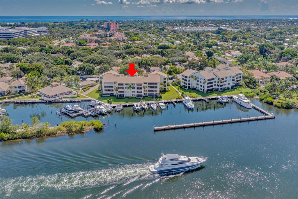 A beautiful waterfront condominium to own in the sought-after Community of Oak Harbour in Juno Beach!  Your direct intra-coastal views provide an exciting array of passing boats to watch--whether mega yachts, sailing, kayaks or day boats.  The wide expanse of Hurricane impact doors open to the porch and hurricane impact windows are throughout.  Exceptional craftsmanship and millwork abound with crown molding and special trim in all rooms, 9 ft ceilings and solid wood interior doors.  A feast for your eyes will be the upscale kitchen with Viking stainless steel appliances, quartz counters and fine Brazilian walnut cabinets with lighting above and below.   Matching are built-ins in the living and dining rooms for a sleek and contemporary look. There has been exceptional attention to detail: Swarovsky ceiling and hallway lighting; custom drawers and shelving in all 8 closets, remote control window shades and wifi washer, dryer, and a Nest thermostat to monitor the home's temperature.   Enjoy the turnkey benefit of this unit with its designer furnishings that are included in its sale, plus its 3 large-screen smart TVs!  Definitely a "find" for the discriminating buyer who enjoys a luxury condominium.