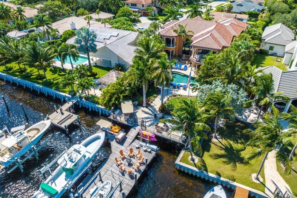 This direct Intracoastal estate was built for boating and car aficionados. The oversized concrete & ipe dock features two boats lifts (22,000 lbs and 14,000 lbs), plus a no-wake-zone social slip. Ocean access is minutes away. Designed with entertaining in mind, the temperature-controlled saltwater pool and waterfall spa area features 4 seating areas, fire pit, outdoor kitchen, and separate bar. The showroom double height garage offers parking for up to 6 vehicles, plus a significant workshop area, and staircase leading directly to a man cave and gym.Inside, you will find five bedrooms and seven baths, Turkish limestone floors, a spacious gourmet kitchen with mahogany cabinets, granite countertops, and Thermador appliances. Additional amenities include an elevator, full-house generator, multi-zone air conditioning, full impact glass, CBS block construction (filled with concrete), safe-room, wall safe, deep 15,552 sqft lot, and and private cut-de-sac location.

Please allow 24 hours notice for showings. Proof of funds required for showing.
