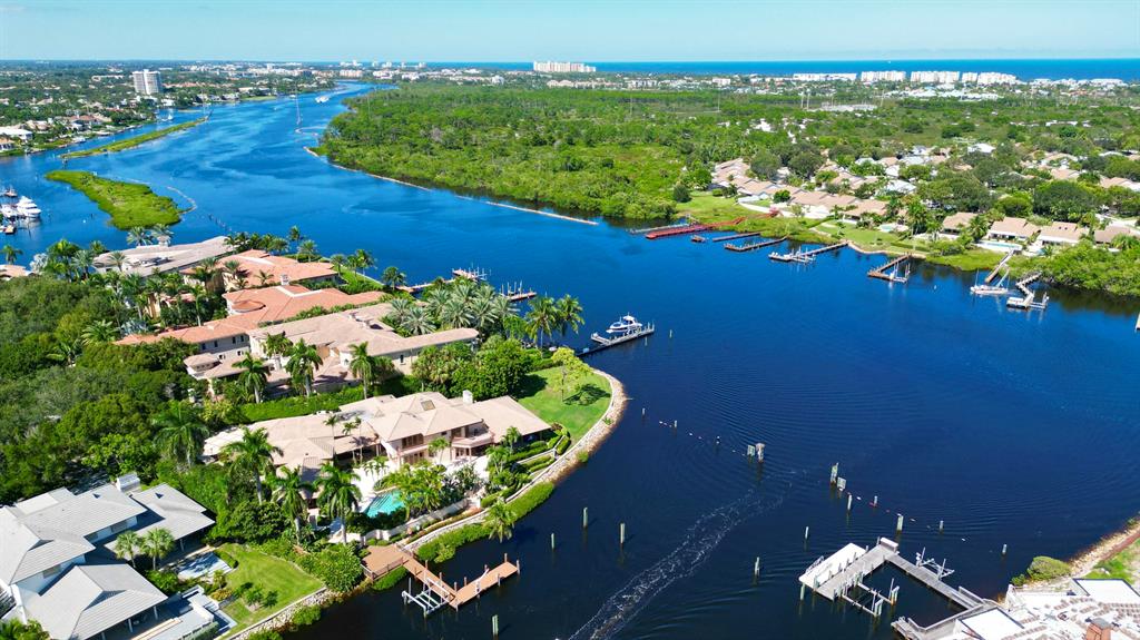 TROPHY PROPERTY with 300' of waterfrontage and Southeast exposure.  This property is one of VERY FEW properties that has direct Intracoastal frontage and protected waterfrontage for a large yacht. This Transitional style home is located on a quiet cul-de-sac with a park like setting in Prestigious Admirals Cove.  Main house features a large luxurious primary suite with dual baths and closets, walk-in shower and spa like tub with panoramic water views, open kitchen to family room, glass and wood bar, cozy living room with fireplace, atrium and much much more!  Guest house has bedroom/living room, kitchenette, and private bath, all situated around the private pool and patio.This is the perfect opportunity to have it all!