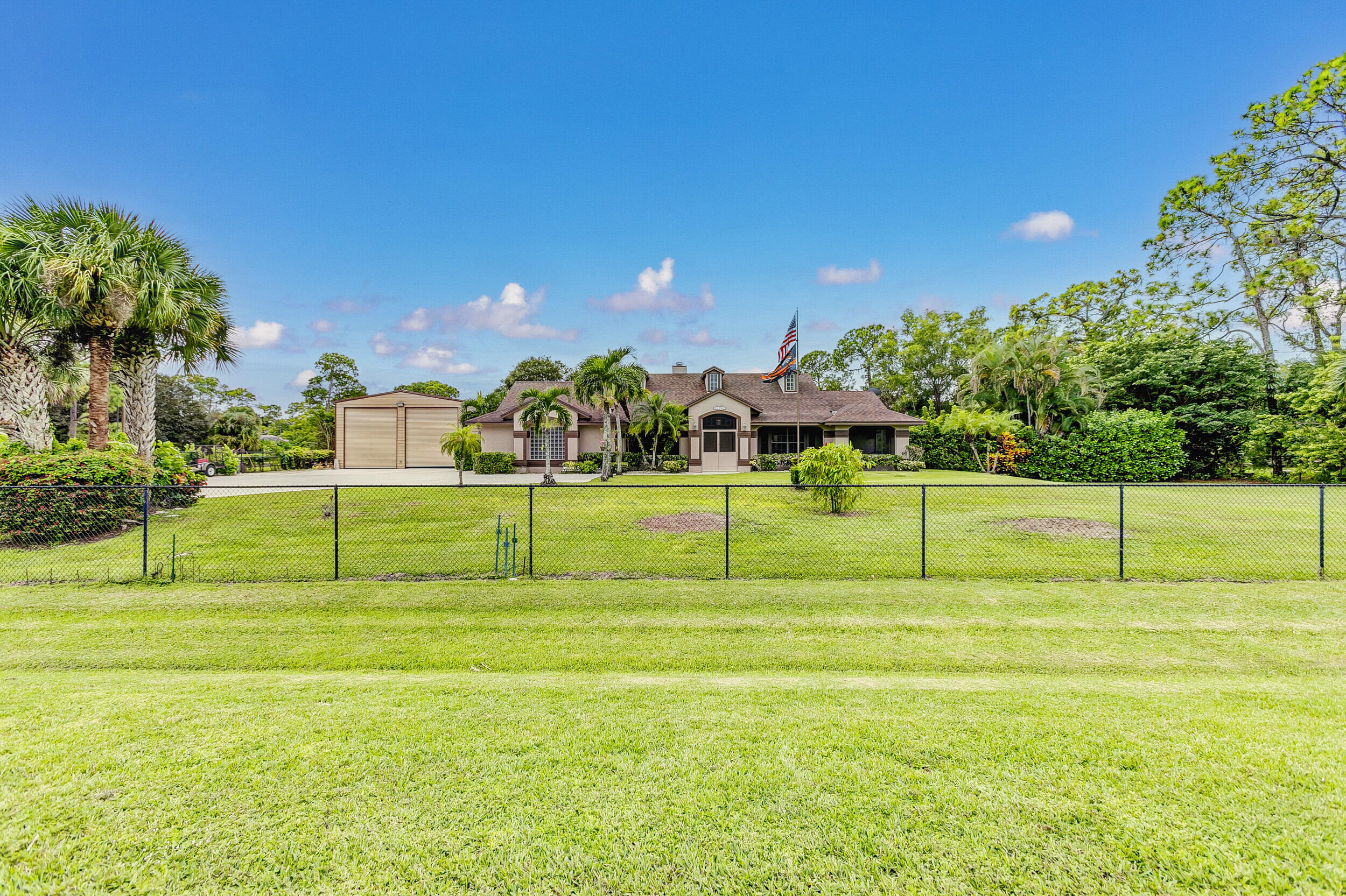 Never listed on the MLS! Beautiful single family pool home on 1.31 acres in Loxahatchee. Has a garage that will fit 2 40' campers, measures at 30' x 50', plenty of room for parking with a huge driveway & 2 car attached garage. Lot is completely fenced & very private, also has a canal on the East side of the property for more privacy. Updated kitchen with new appliances, backsplash & counter tops. Split bedroom layout  & a great back patio for entertaining! Wiltshire Rd is a paved road and has easy access to Seminole Pratt and Okeechobee Blvd. AC 2015, Roof 2019, Solar Water Heater 2019