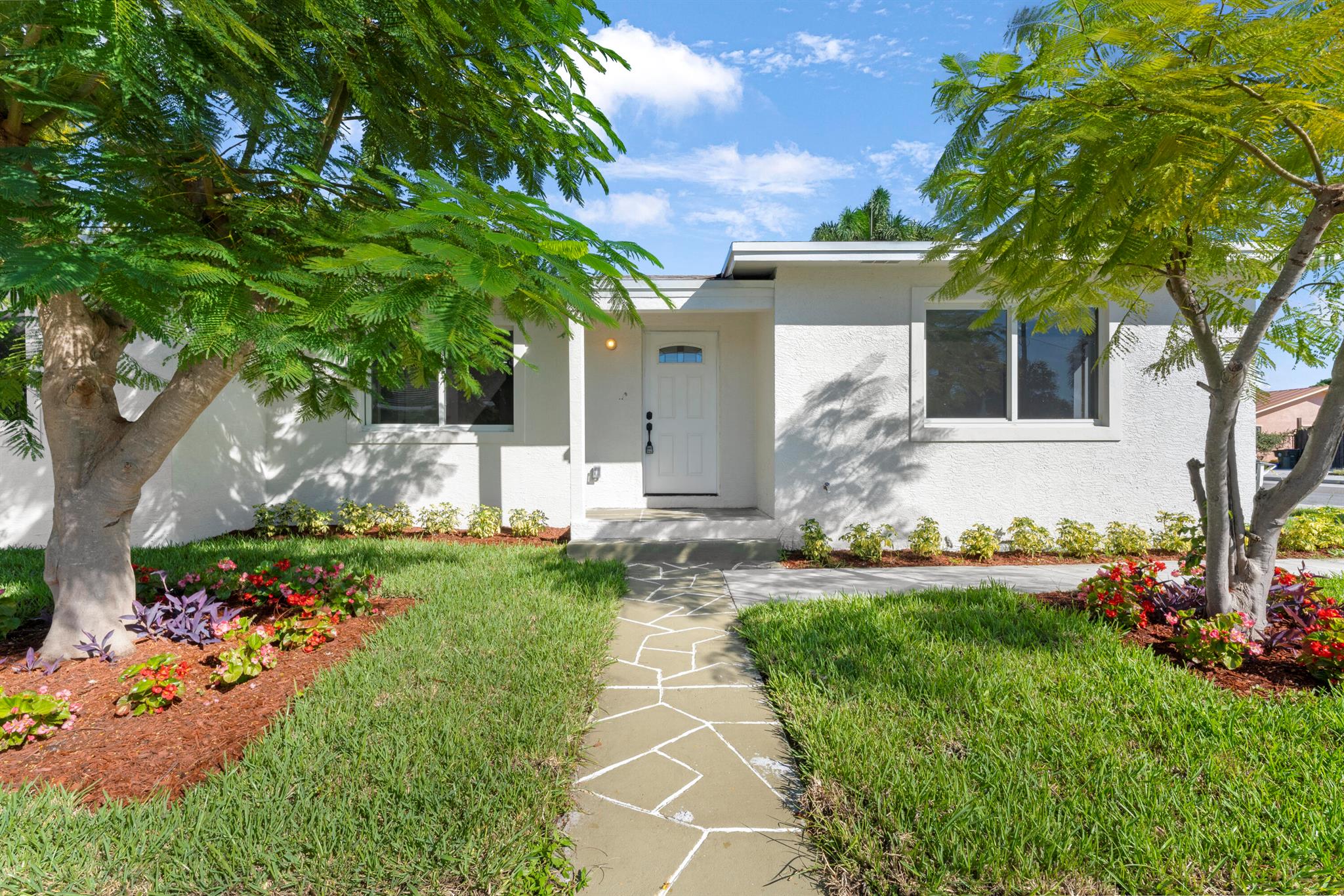 Conveniently located in a quiet neighborhood in Lake Worth, this 3-bedroom, 2-bathroom home has been completely remodeled with high quality accents and finishings, including new flooring and impact windows throughout. The kitchen features quartz countertops, brand-new stainless-steel appliances, and a large peninsula that can accommodate up to three counter chairs. It opens to the light and bright living room, which leads to the completely remodeled master suite and two additional bedrooms. With a brand-new roof, water heater and paved driveway with space for multiple cars, this single-family South Florida retreat is move-in ready and conveniently located close to local restaurants, shopping and entertainment.