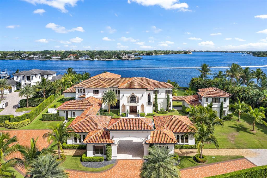 Welcome to Villa Real, a Breathtaking estate of incomparable elegance sited on the largest assemblage of Waterfront land currently available in Jupiter: Just under 4 acres  with 254' of stunning wide water views.  Offering the Ultimate in  privacy + security, this palatial residence boasts an imposing 18,302 sq. ft.    A gated 640' palm treed drive leads to this stunning abode.  Masterfully built in 2016 by award winning Anderson Moore using only the finest materials, this home is a true classic modern Palazzo.  Interiors  include a soaring 2 story entry, stunning wood + marble works and bespoke fixtures, creating a magical ambiance.  Finely curated furnishings provide an exquisite move in ready haven. The hub of the home is the grand kitchen and family room - a sprawling area of luxury A private elevator or grand staircase leads to the second level and upper gallery.  The Owner's suite is an oasis of unparalleled luxury, from the grand hall entry with bar to the opulent marble bath and dual wardrobe rooms.  A private loggia offers exquisite serenity.  An additional 6 spacious bedrooms with ensuites + large closets are in the main house.  A separate 1,800 SF guest house has 2 additional ensuite bedrooms.  Villa Real offers every amenity of comfort + style, from the dramatic double level pool to huge waterfront loggias w/ fireplace and summer kitchen and a home theatre. Enchanting grounds with endless water views + Ocean breezes  A 107' dock along the Loxahatchee River provides a protected and easy path to the Jupiter Ocean Inlet.   A beautiful life awaits you...