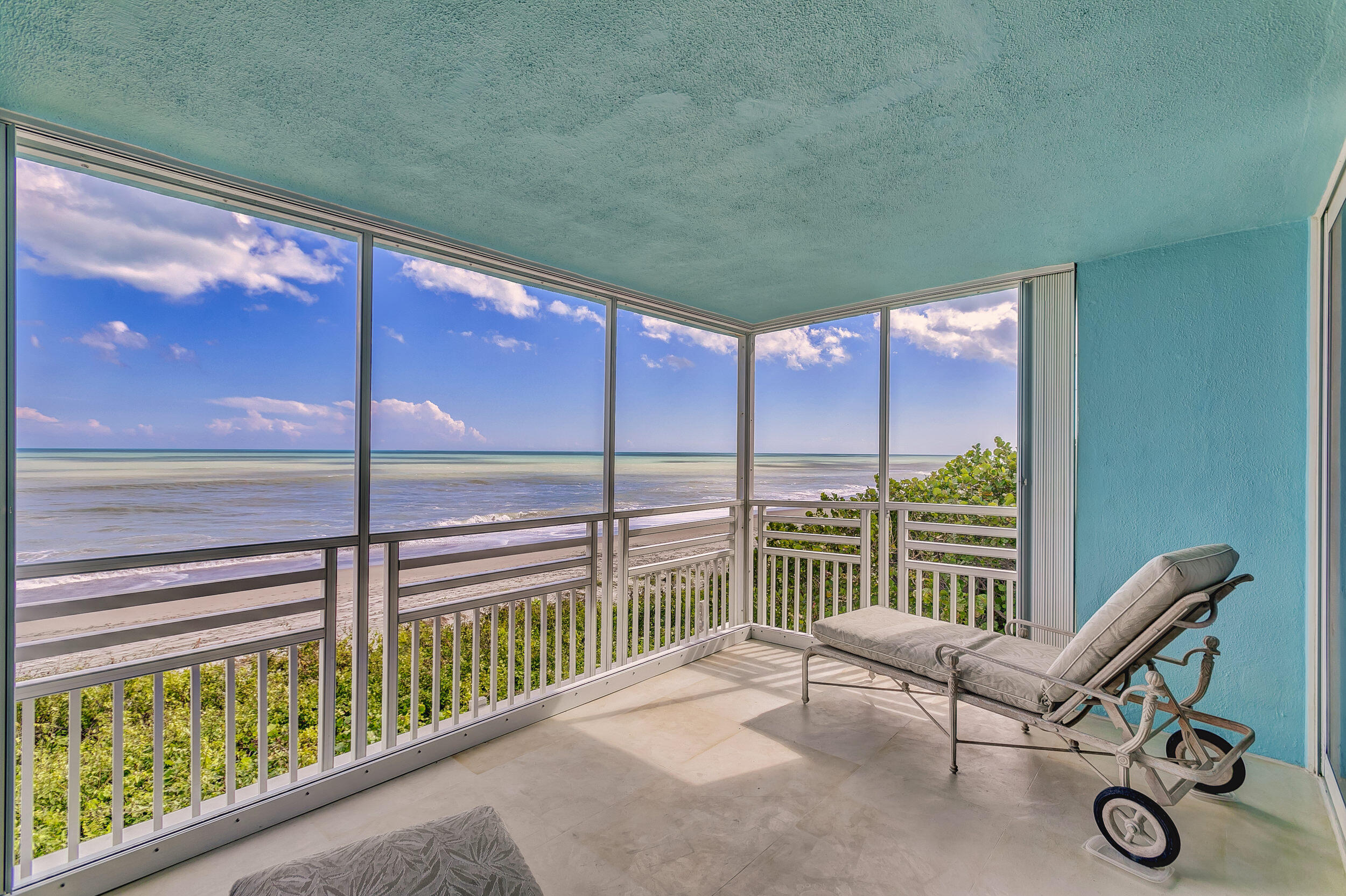 Paradise calling!  Spectacular ocean views from nearly every room of this direct oceanfront corner unit with coveted southeast exposure in the heart of Juno Beach.  This rarely available 3 bedroom, 2 bath unit has been totally renovated.  Just move in and enjoy.  Impact Glass, marble flooring, tankless hot water heater, large open kitchen with island, fine wood cabinetry and high end appliances. The unit is used as a 2 bedroom with the third bedroom utilized as a hobby room.  Wake in the morning to breathtaking sunrises.  Take a walk on the beach to start your day.  Ride a bike along Ocean Drive to one of the many nearby cafes. Building amenities include elevator, 24-hour gated parking with video surveillance, oceanfront pool, assigned storage, plus common area storage and clubhouse