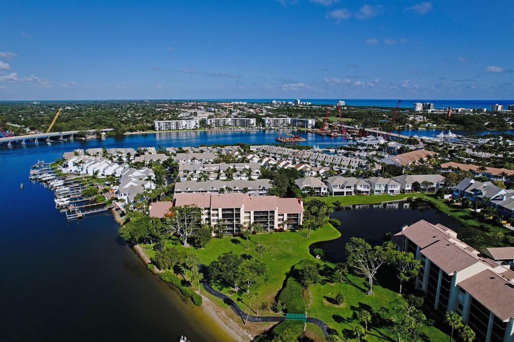 Prime location in the heart of Jupiter. Don't miss this opportunity to own a beautifully renovated condo in Jupiter Harbour with spectacular, direct intracoastal views. This 2 bedroom, plus a den, end unit offers all the perks of a maintenance free condo lifestyle yet still feels like a home. Immediately you will be drawn towards the pecky cypress and beam outlined, volume ceilings that illuminate from the abundance of natural light radiating through each window. This stunning unit has been renovated with 24 x 48 grey slate tile and LED recessed lighting throughout the main living areas. New wood shaker kitchen cabinetry with GE stainless appliances, convection oven, heating drawer, stainless large apron sink and Bianco Rhino marble countertops.  Please see additional remarks... The cozy den with double glass doors, can easily be converted into a third bedroom or office space and features an under counter wine refrigerator with stainless steel countertop and built-in wood cabinetry.  Open family room and dining area with wood burning fireplace. Enjoy expansive Intracoastal, garden or lake views from almost every room or on either of the two large balcony areas.

Additional features include textured entry wallpaper, laundry room with new front loading washer and dryer, new shaker solid core interior doors, 6" contemporary style baseboards. Powder room with white quartzite countertops. Master offers large windows overlooking the majestic Intracoastal waterway with porch access, electric window treatments, and built-in closets. Master bath has an oversized shower, dual sinks and wood cabinetry. Split floor plan offers guests a private ensuite with a walk-in closet. Unit has been freshly painted, has electric accordion hurricane shutters throughout, 3 storage closets and one assigned carport space. Community amenities include 24 hour manned guard gate, community pool, spa, tennis courts, walking trails, marina and sandy beach for easy water sport launching. Boat spaces are sold or rented separately. Easy access to Harbour side and Jupiter Riverwalk to enjoy fine dining and live music. No Pets!