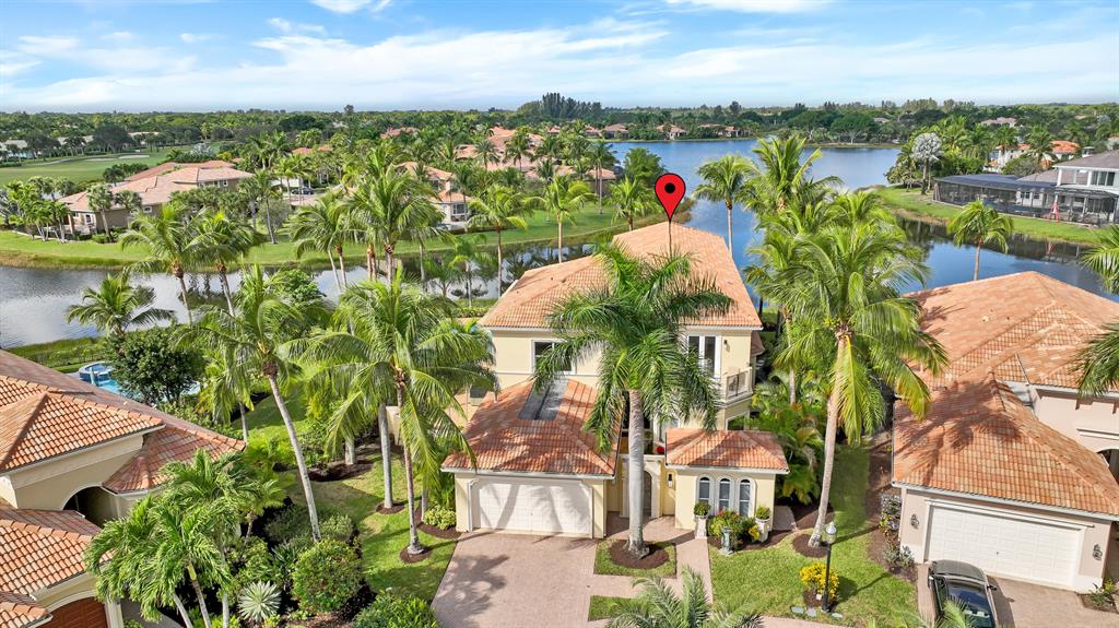One of the most amazing, fabulous custom homes in Ibis with wide & long water views! Located on the Terra Lago cul-de-sac this home sits on 1/3 acre pie-shape lot with almost 180* of water view. Soaring 22' ceiling in the massive living room/bar with Stone Gas Fireplace & large impact glass which gives lots of light & triple coffer ceiling. The large marble bar includes a sink. Family Room includes a stone wall and decorative box ceiling along with large impact glass. The spacious kitchen includes double dishwasher, island with prep sink & quality wood cabinets. The breakfast nook has access to the pool/patio area. Beyond the gracious dining room & stairs is the den with wood carvings from overseas. The unique cabana style powder room has a vessel sink & ceiling details. See More!