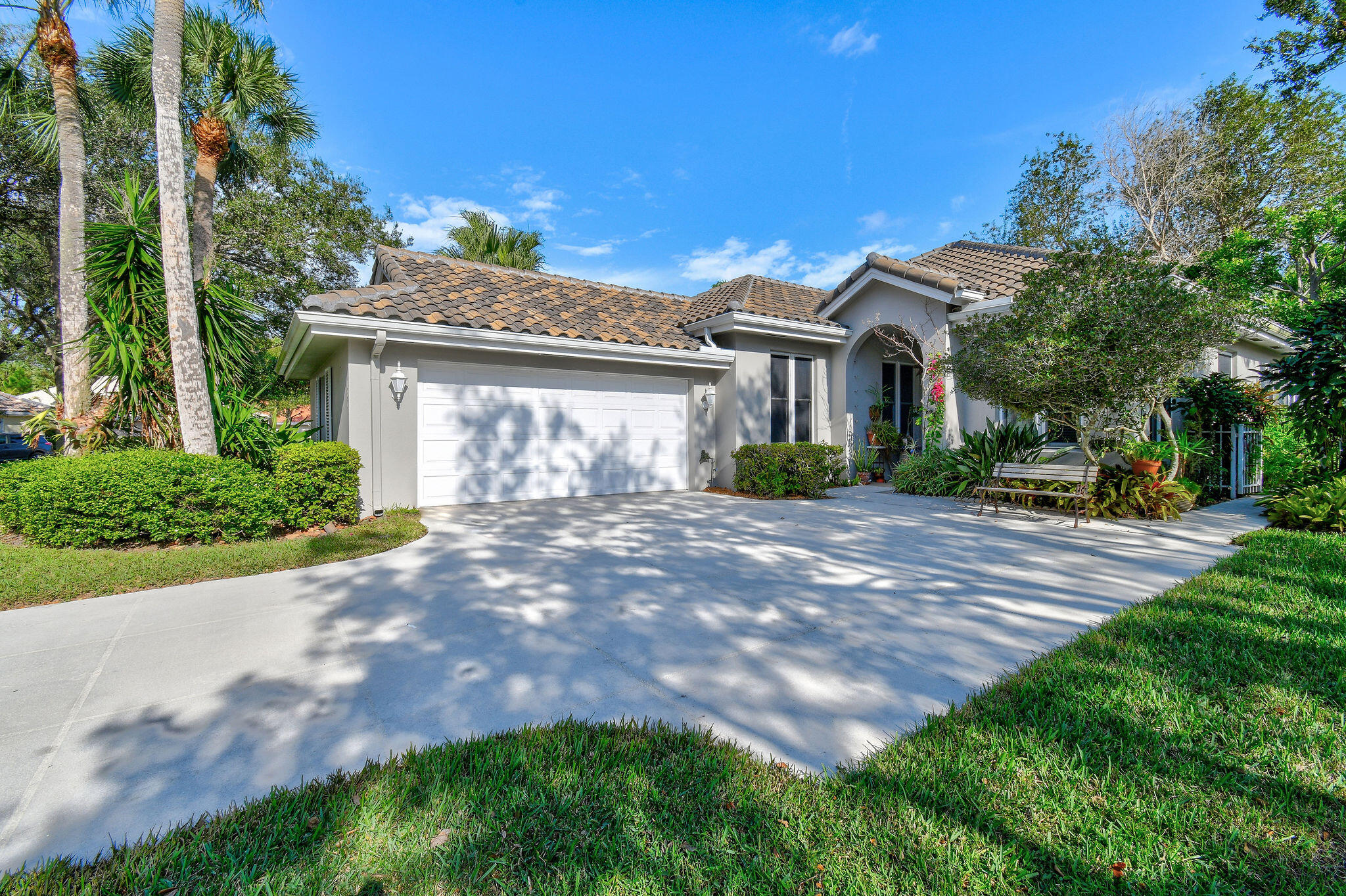 Highly desirable Hamptons home with a split floor plan. Three bedrooms and two full bathrooms, and a two car garage, located in the heart of Jupiter. Spacious living room and kitchen, 10' ceilings throughout with lots of natural light from sliding glass doors leading out to the backyard sanctuary overlooking the lake. The primary suite has a layout with walk-in his-&-her closets, a separate tub and shower, dual vanities. Large laundry room with cabinetry leads out to the 2 car garage which has a ton of storage and space. Fantastic location with A-rated schools.