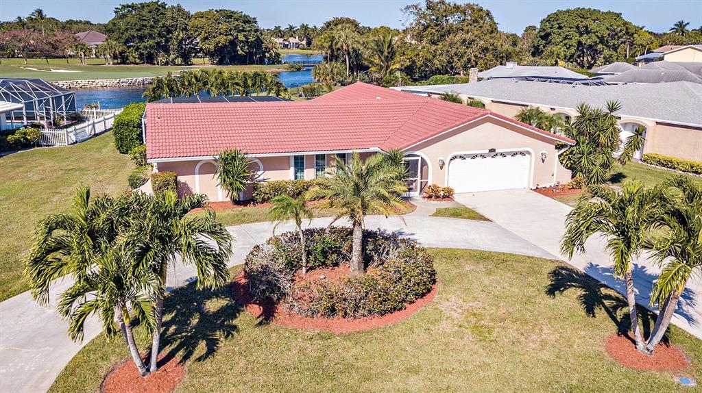Fabulous oversized lot on water overlooking Ballenisle golf course. Rare find with no HOA Fees. Large 4 bedroom with 2 and 1/2 bathrooms waiting for your personal touches. CBS construction with impact glass and accordian shutters throughout the home.