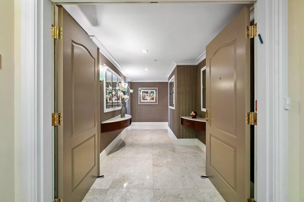 Architect's personal residence, substantially upgraded and decorated; can be offered finely furnished and fully turnkey. Elegance awaits in this spacious corner 3 bed 3 1/2 bath condo in the heart of Downtown Boca Raton. As you enter through the double front doors and pass through the private foyer adorned in  silk wall coverings, you are greeted with abundant natural light. Floor to ceiling impact windows lead to 3 spacious covered balconies, totaling 300 sq ft. Meticulously crafted, the home features coffered ceilings, custom cabinetry and draperies, hard surface flooring throughout, stainless steel Thermador Appliances, paneled refrigerator, Miele in-wall coffee machine and granite countertops.The primary suite has two walk-in closets and bathroom en-suite, with double vanity, whirlpool