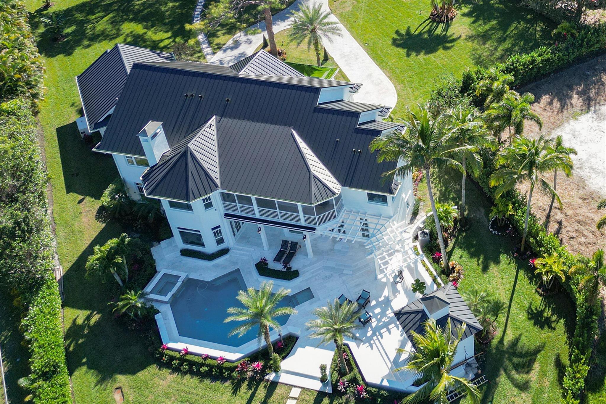 AFTER TWO YEARS OF EXTENSIVE RENOVATIONS, THE ''RIVERDANCE'' ESTATE IS FINALLY FINISHED.This masterpiece has been meticulously overhauled by a renowned local designer and constructed to maximize space and river views by the best builders. Completed in January 2023, this fully furnished estate includes a 4 bed/6 bath main house, a 3bed/2.5 bath guest house, pool with outdoor kitchen, ocean access, 8 garage spaces, elevator, and designer selected finishes throughout.The gated compound is comprised of 2.5 acres of open, landscaped area; the options are endless with this yard to add a professional golf green, full tennis and/or basketball court, or possibly a giant play area. The breathtaking 2,000 square foot owner's suite boasts his and her bathrooms and massive closets.

There are two large upstairs bedrooms, with en suite bathrooms. An additional fourth bedroom/office downstairs, also with en suite. 

A commercial sized elevator and a 100" laser projector TV are featured with European white Oak floors and a custom glass wine wall. 

Several windows were added to bring in natural light and allow expansive views. 

A detached, three bedroom, two bath Guest house over a 5 car air conditioned garage, makes this a unique space for a car collector, storage, and/or catering events. Plus an additional maintenance garage and 2-car garage at the main house, totaling 8 covered spaces.  

Over 3,000 plants were brought in to enhance the well maintained landscape. 

There is a boat dock with covered boat lift up to 16K lbs and also a launch pad for kayaks and paddle boards. 

White marble surrounds the heated pool and spa. A summer kitchen and retractable awning maximize the outdoor space.

From the moment you pull up to the gates, you will be smitten by the grandeur of Riverdance. Don't miss out on this remarkable opportunity to own a small slice of heaven.