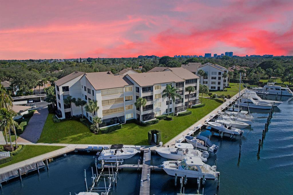 ***CONDO+BOAT SLIP W/12K LBS. BOAT LIFT C-1 PACKAGE*** Waterfront Jewel on the top 4th floor with DIRECT, UNOBSTRUCTED, BEAUTIFUL AND PANORMAIC INTRACOASTAL WATER VIEWS IN THIS GATED, PRIME LOCATION, PRIVATE COMMUNITY! Preferred South/WEST exposure FOR THE BEST SUNSETS AND BOAT WATCHING. ONLY THE 'PENTHOUSE'' 4TH FLOOR OFFERS AIRY & VAULTED CEILINGS, with a spacious full 2 BR w/ 2 Bath floorplan. Transitional interior & styling. Trane AC with an Air Purifying System. All around hurricane windows or rated Rolladen Shutters, complete the expectations for this sought after South Florida Coastal Lifestyle! SEE ADD. PUBLIC REMARKS FOR  ALL DETAILS. The small &amp; gated community, nestled between picturesque Oak trees ("Oak Harbour"), offers a private marina, heated pools &amp; spa, tennis/pickle ball courts and a waterside Club house with a functional gym &amp; wide deck area for ultimate relaxation and enjoyment. Manager on site. PRIME LOCATION. Just minutes to the area's beautiful beaches, best shopping, dining &amp; entertainment and 20 min. to the Palm Beach International airport! Association fees also include Internet and Comcast Cable with Movie channels!
The Boater's Paradise Package includes:
- Separately deeded boat Slip C-1 with 30 ft. dock, within sheltered part of the marina, conveniently located between two inlets with ocean access.
- Furniture is negotiable. Personal staging items do not convey.