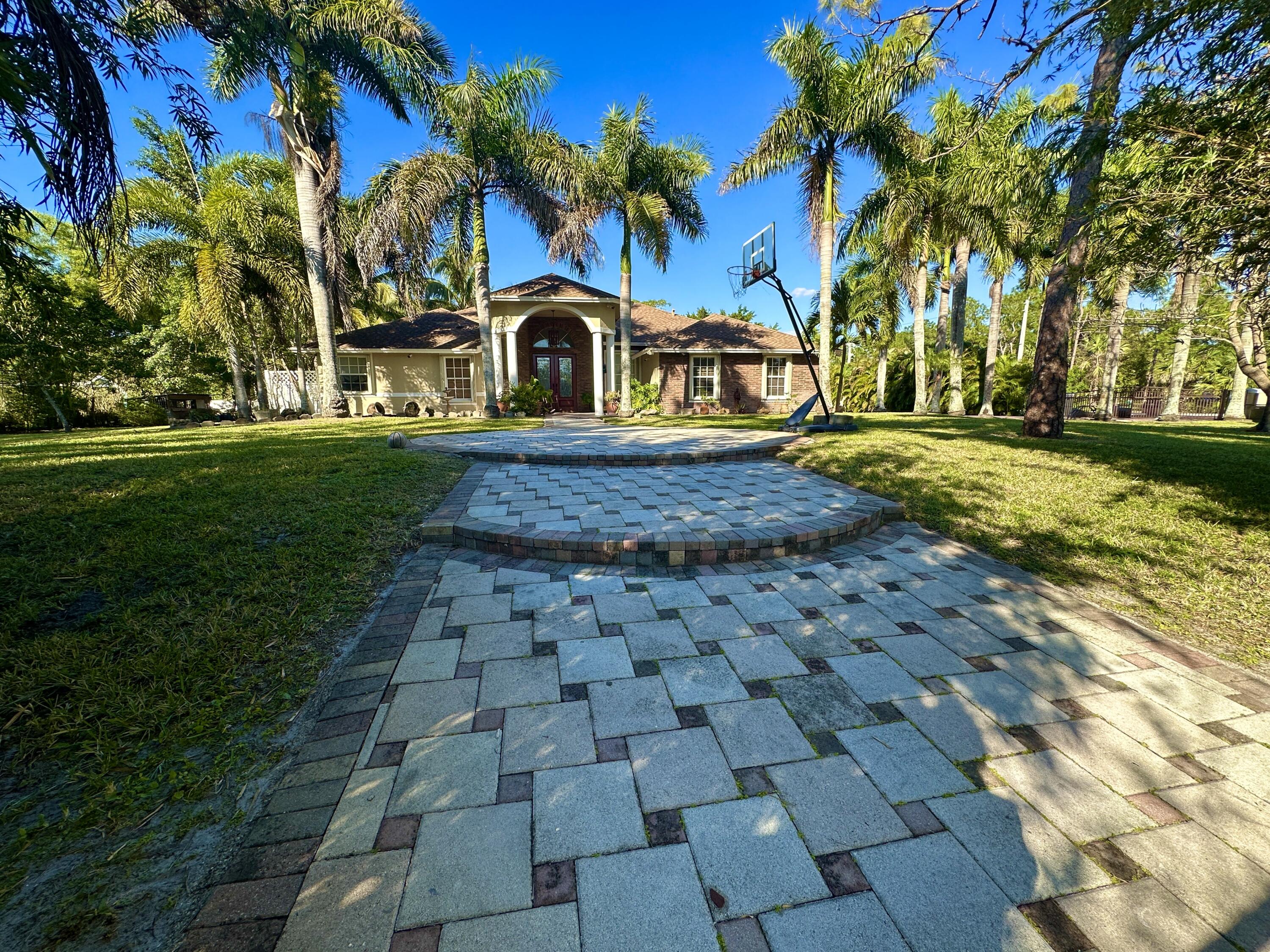 !!!!!  reduced for fast sale !!!!!  ***. CITY WATER *** MOVE IN CONDITION ***. CBS ***ACORDION SHUTTERS  **** RECENTLY RENOVATED  !!!  AMAZING HOME IN LOXAHATCHEE !!!  HAS ALL THE CHECKS , BELLS & WHISTLES ***  WELL MAINTAINED ***. COMPLETE PACKAGE *** !!!  WOW ***.  CITY WATER ***. CORNER LOT **. PAVED ROAD ** FUUL FENCED ***. NO HOA ***. 1.39ACRES ***. 5 BEDROOM 3 BATHROOM POOL HOME WITH DETACHED BUILDING WITH ELECTRIC, WATER AND BATHROOM- CAN BE USED AS GUEST SUITE/ INLAW SUITE / GAME ROOM/ EXERCISE ROOM/ MAN CAVE ***PLUS DETACHED STORAGE/CHICKEN  COOP  !!!  PERFECT HOME FOR ANY FAMILY *** GOURMET KITCHEN WITH GRANITE , NEW APPLIANCES 1 MONTH , BREAKFAST BAR, BREAKFAST NOOK AND RELAXING VIEW OF POOL AND FRIENDLY LARGE FAMILY ROOM !!! 3 WAY SPLIT *** IN CALIFORNIA  CLOSETS *** SHOWER AND SEPARATE TUB **. THIS BEAUTY ALSO BOASTS FORMAL LIVING, FORMAL DINING AND NICE FAMILY ROOM AND GREAT ENTERTAINING LANAI AREA *** NO HOA - BRING THE RV, BOAT TRAILER AND HORSES **. CITY WATER *** PAVED ROAD ** CORNER LOT *** 5TH BEDROOM HAS PVT BATH / CABANA BATH WITH EXTERIOR ACCESS - GREAT FOR GUEST/ INLAWS ***. MINUTES TO FRONTIER ELEMENTARY &amp; OSCEOLA MIDDLE SCHOOL **  AND MINUTES TO SHOPPING, BANKS, LIBRARY, HIGHWAYS AND BEACHES **.  ACORDION SHUTTERS