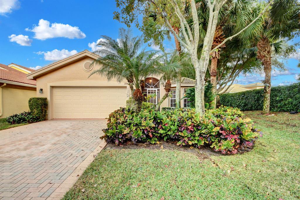 Enjoy every day in this showplace lakefront home located in gated Valencia Palms. Stunning open-concept floor plan features ceramic tile floors & soaring vaulted ceilings plus updated fixtures & finishes throughout the expansive living spaces. Eat-in kitchen features custom cabinetry, granite counters, and seated bar. Owner's suite features tray ceiling and includes en suite bath featuring dual sink and seated vanity, separate tub and walk-in shower. Covered and screened lanai offers plenty of space for outdoor seating, dining, and entertaining. Oversized brick driveway with attached double garage A/C 2020 and tankless hot water heater. Valencia Palms is close to the area's best shopping, dining, recreation & features  amenities including clubhouse, Cafe, fitness studio, pickleball, tennis