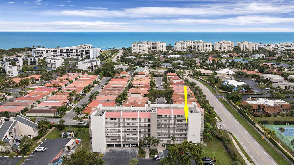 This desirably located 3B 3B condo is approximately 500 yards to the beach in the lovely Jupiter Ocean and Racquet Club. With 1800 square feet of living, the condo comes with one of only four sought-after covered parking spaces and features updated bathrooms and kitchen with granite countertops, stainless steel appliances, and newer cabinets. The third bedroom has been converted into a den/office with a sitting area and bar and has access to the sunny southeast ocean breezes from the screened in patio. It can be easily made back into a third bedroom. Plantation Shutters on the windows offer light and privacy. Tile floors throughout.
