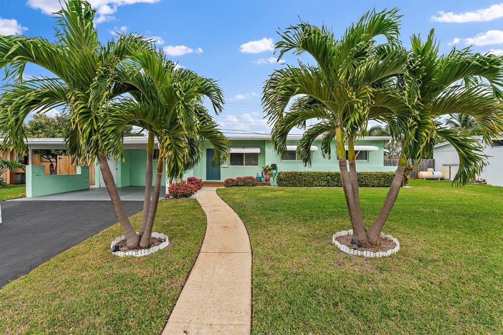 Mid Century Modern done to PERFECTION! Awesome move-in ready CBS home in the Village of North Palm Beach! Adorable curb appeal with new landscaping and welcoming front porch. Tons of natural light fill this adorable with through the newly installed impact windows. The modern white kitchen and bathrooms were recently updated but the ''Old Florida Charm'' remains with beautiful Terrazzo flooring throughout.  The open Florida room adds lots of extra living space and flows perfectly out to the full fenced and private backyard. This home is perfectly located just minutes away from beaches, shopping and restaurants. NO HOA! Great investment opportunity with no rental restrictions! Don't miss this gem!