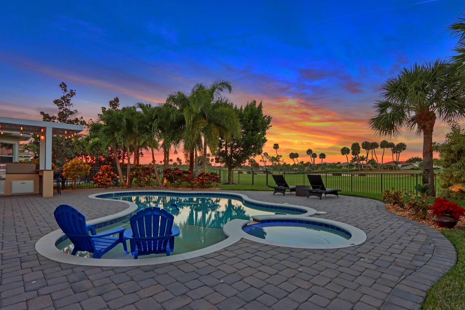 Enjoy the ultimate Florida country club lifestyle in this immaculate home located on the 13th hole of the Jupiter Country Club! This tropical oasis has a large yard and patio with a freeform, salt-chlorinated pool & spa, summer kitchen, electric gazebo roof and tropical landscaping.  This single story home has 3 bedrooms + den, 3 full baths and 3 car garage. The double glass door entry opens to the great room with soaring ceilings and fantastic views of the pool and golf course.  The kitchen has granite counters, custom backsplash, stainless steel appliances including gas stove, breakfast bar and eat in kitchen.  Owners suite overlooks the pool and has dual closets with custom shelving and luxurious bathroom. Other features include travertine floors, planation shutters, 14" tray ceilings, impact glass windows, upgraded lighting, freshly painted, AC with UV light air purification system, surround sound inside and out, 3 car garage with epoxy flooring and built in storage systems. Jupiter Country Club is a gated golf community with a Greg Norman designed golf course, resort style amenities including 6 Har Tru tennis courts, formal &amp; casual dining, pickle ball, fitness center, 2 pools, bocce and basketball. Intermediate golf membership is grandfathered and available for purchase to the buyer of this home.