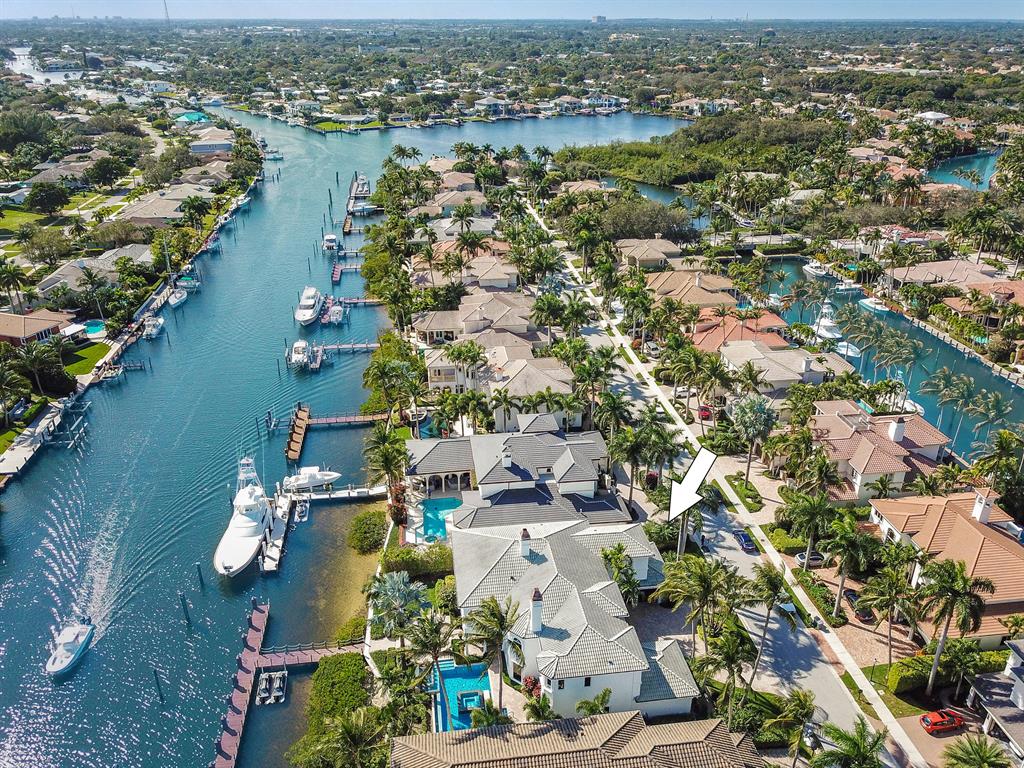 Charming estate home located on 100ft of water frontage in the highly desirable gated community of Harbour Isles. This is a unique lot that can accommodate up to an 80ft vessel. As you walk into the inviting entryway of the home you are greeted with serene views of the water feature of the resort style pool/spa, the tranquil flow of the waterway, and just beyond that, are views of the lush greens of the North Palm Beach Jack Nicklaus ''Signature'' Golf Course. This home boasts 5 bedrooms, 6.2 bathrooms, 3 car garage, private pool/spa. Renovated in 2015 and a refresh of custom interior decorating, this home offers impact glass, 38KW generator, a gourmet kitchen with double Subzero refrigerators, Wolf 6 burner gas cooktop with range, warming drawer, two dishwashers, ice maker, Viking wine cooler, large covered loggia and summer kitchen, setting the perfect atmosphere for entertaining, relaxing, or enjoying the "catch of the day." Spacious primary bedroom with two bathrooms, two large walk-in closets, an office, separate sitting room, and a second story balcony with sprawling views is a perfect way to watch the sunrise or retire after a day on the water. Four additional en-suite bedrooms with walk-in closets, one suite located on the first floor with a private wet bar/kitchenette area and three suites upstairs, great for family or guests. This home is equipped with an elevator, freshly painted interior and exterior and so many featured upgrades. Offering price includes furnishings. Your home in paradise awaits you!